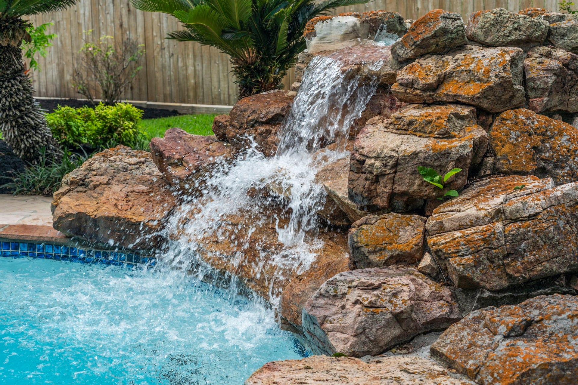 75 Stalybridge Street, Sugar Land, TX 77479 A dramatic rock waterfall adds movement & character to the pool, creating a beautiful focal point within the backyard.