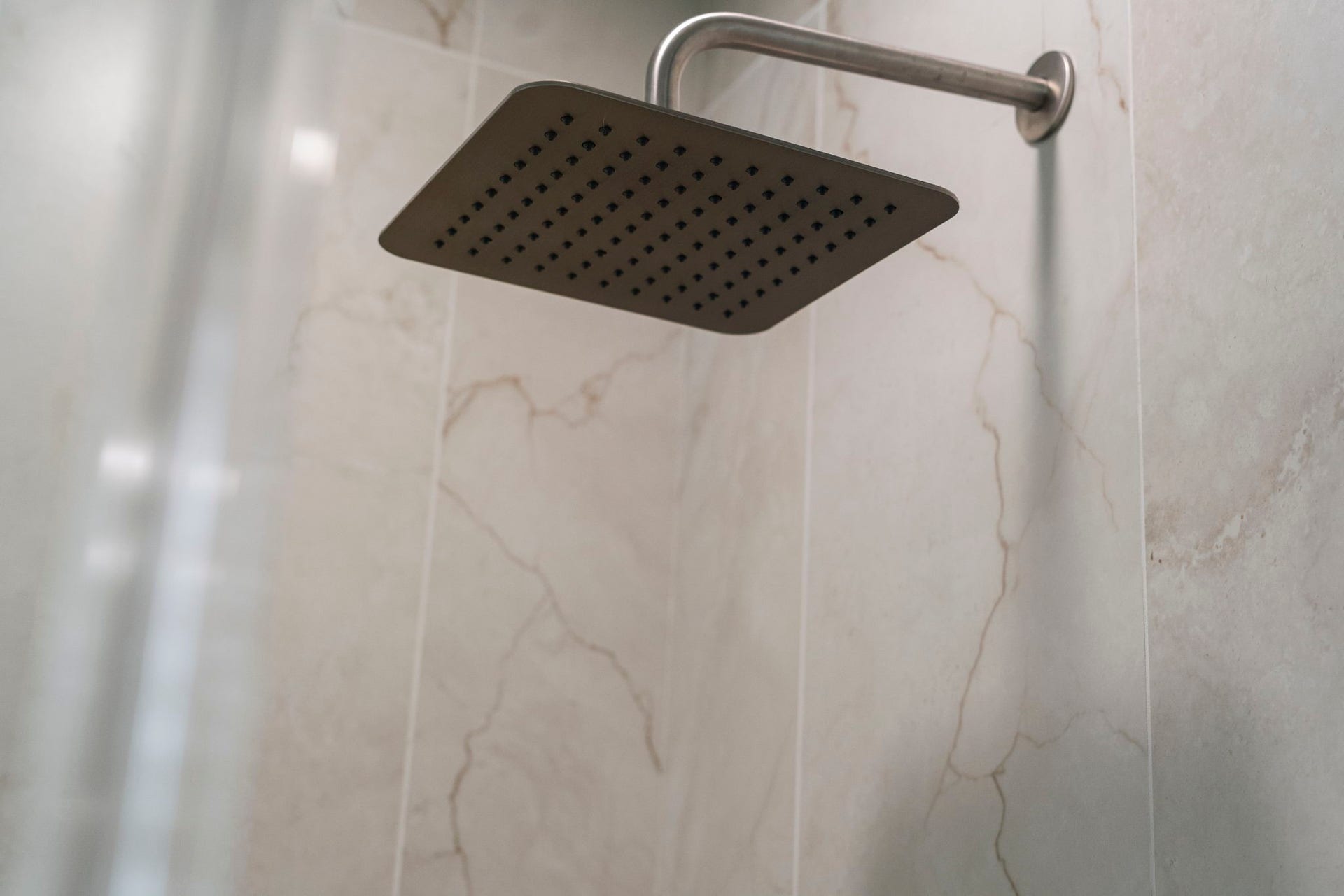 75 Stalybridge Street, Sugar Land, TX 77479 An oversized rain shower head adds a luxurious finishing touch to the beautifully tiled primary shower.
