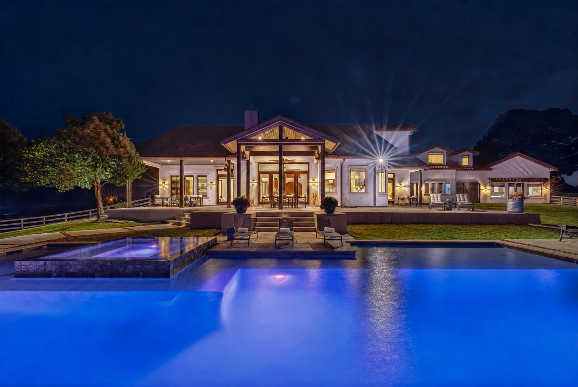 24005 Old Dobbin Plantersville Road, Montgomery, TX 77316 As twilight falls, the illuminated pool transforms home into an unforgettable evening destination.