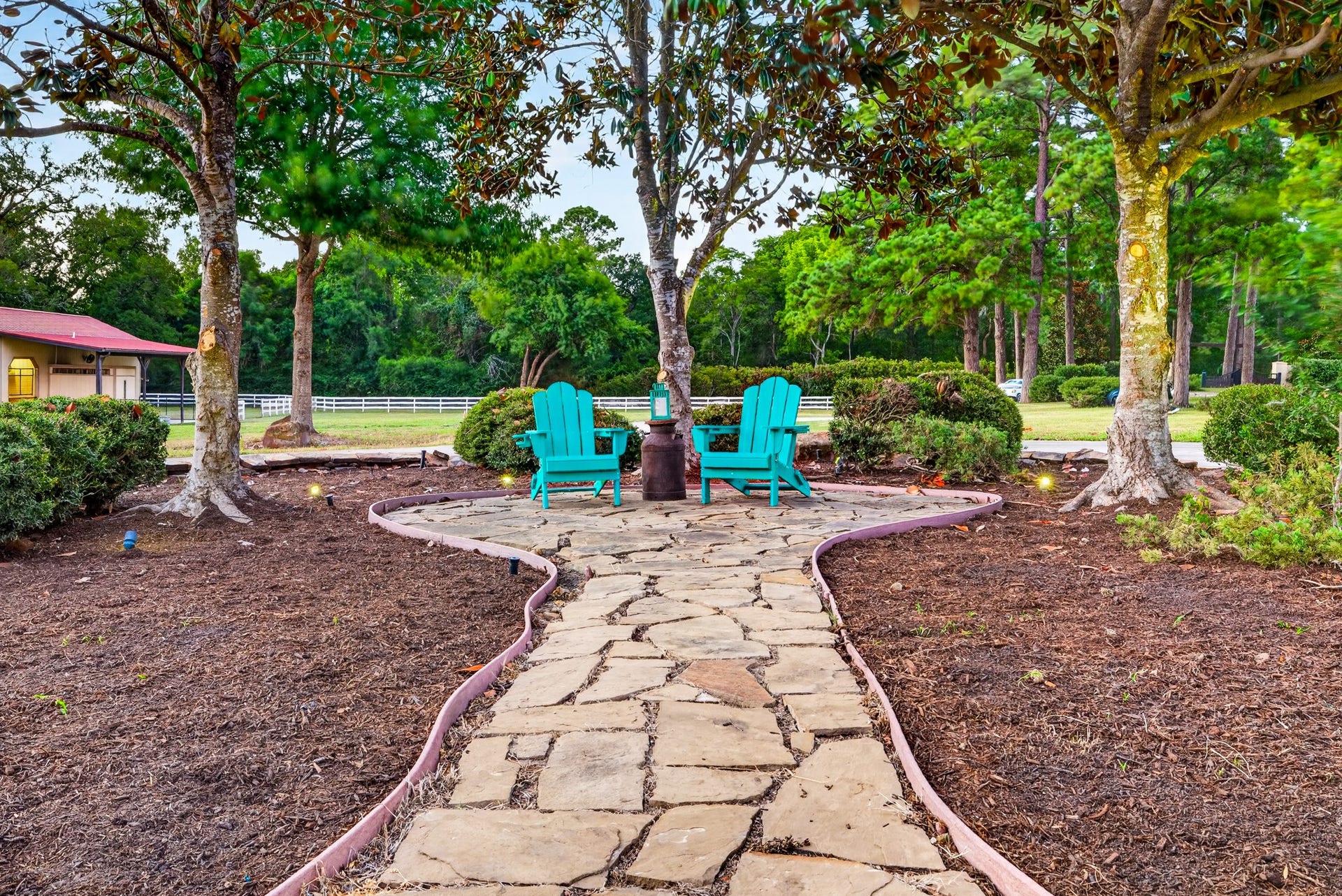 24005 Old Dobbin Plantersville Road, Montgomery, TX 77316 Beneath the oaks, two blue chairs invite conversation, stillness and an unhurried afternoon.