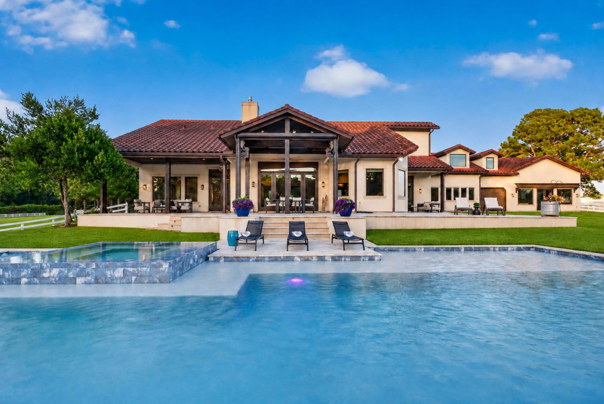 24005 Old Dobbin Plantersville Road, Montgomery, TX 77316 The rear elevation opens gracefully to a poolside terrace designed for effortless entertaining.