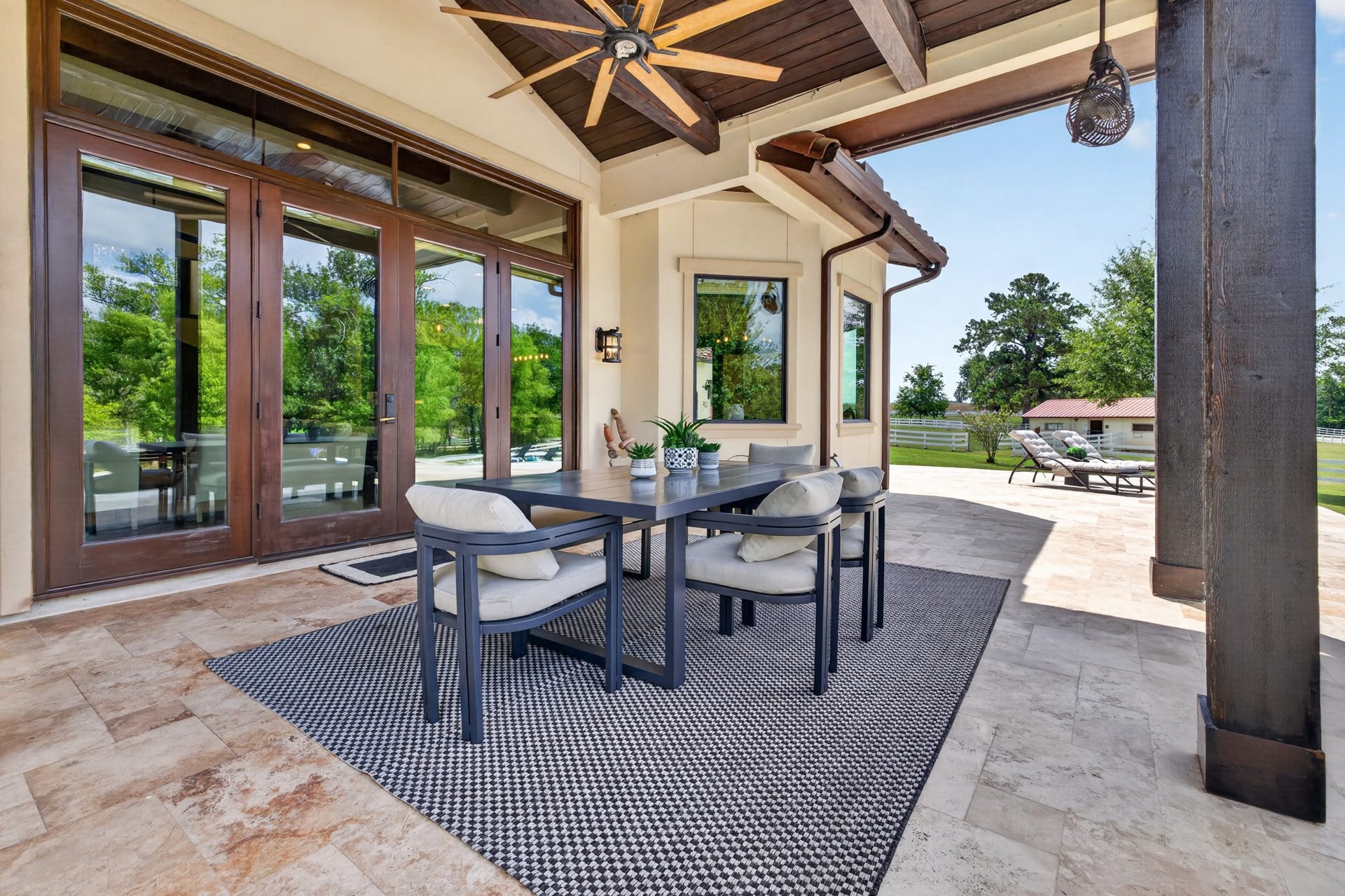 24005 Old Dobbin Plantersville Road, Montgomery, TX 77316 Covered outdoor dining turns family meals into relaxed poolside evenings beneath soaring beams.