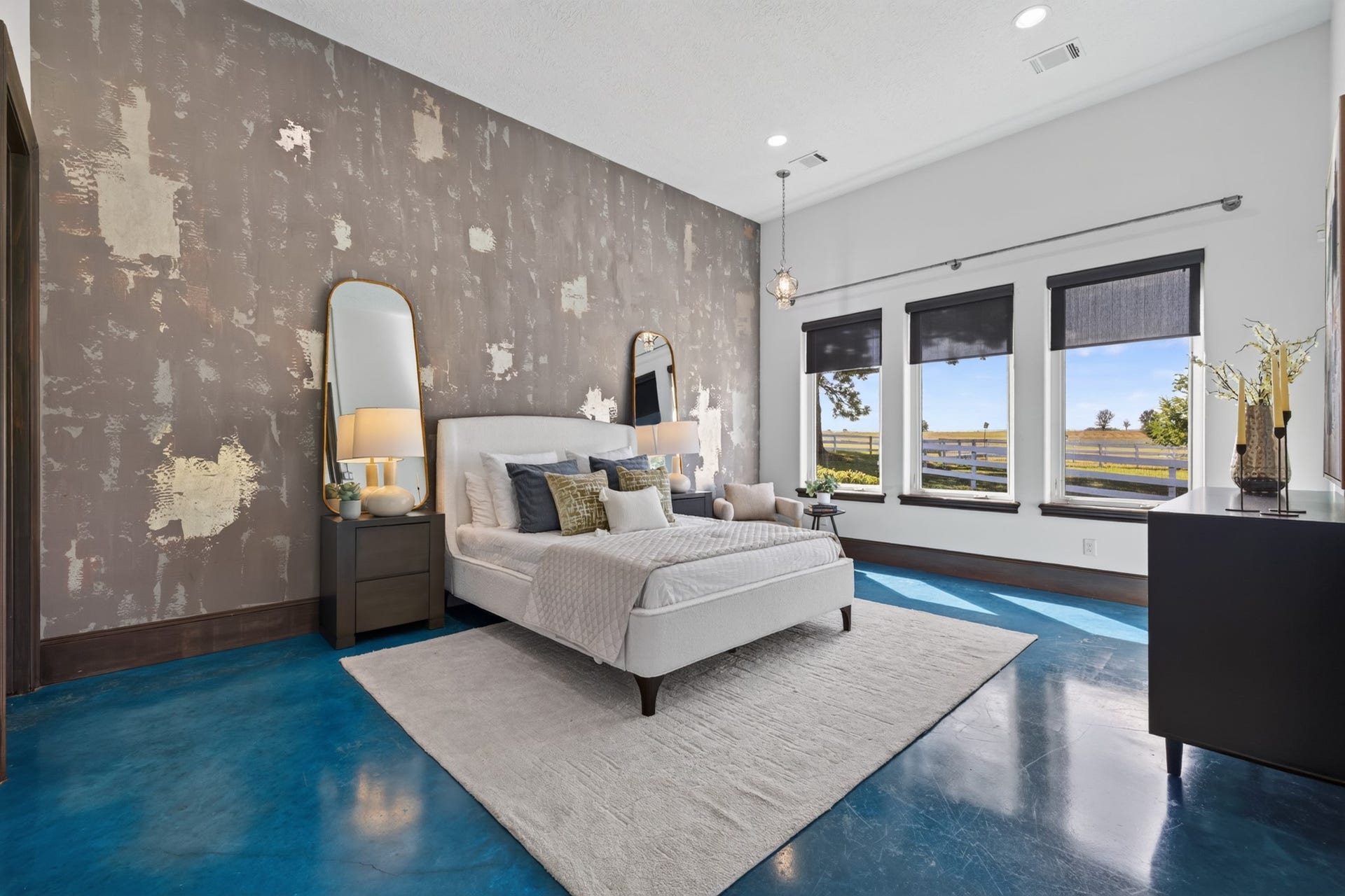 24005 Old Dobbin Plantersville Road, Montgomery, TX 77316 High ceilings and signature blue floors make the Guest Quarters bedroom feel wonderfully distinctive.