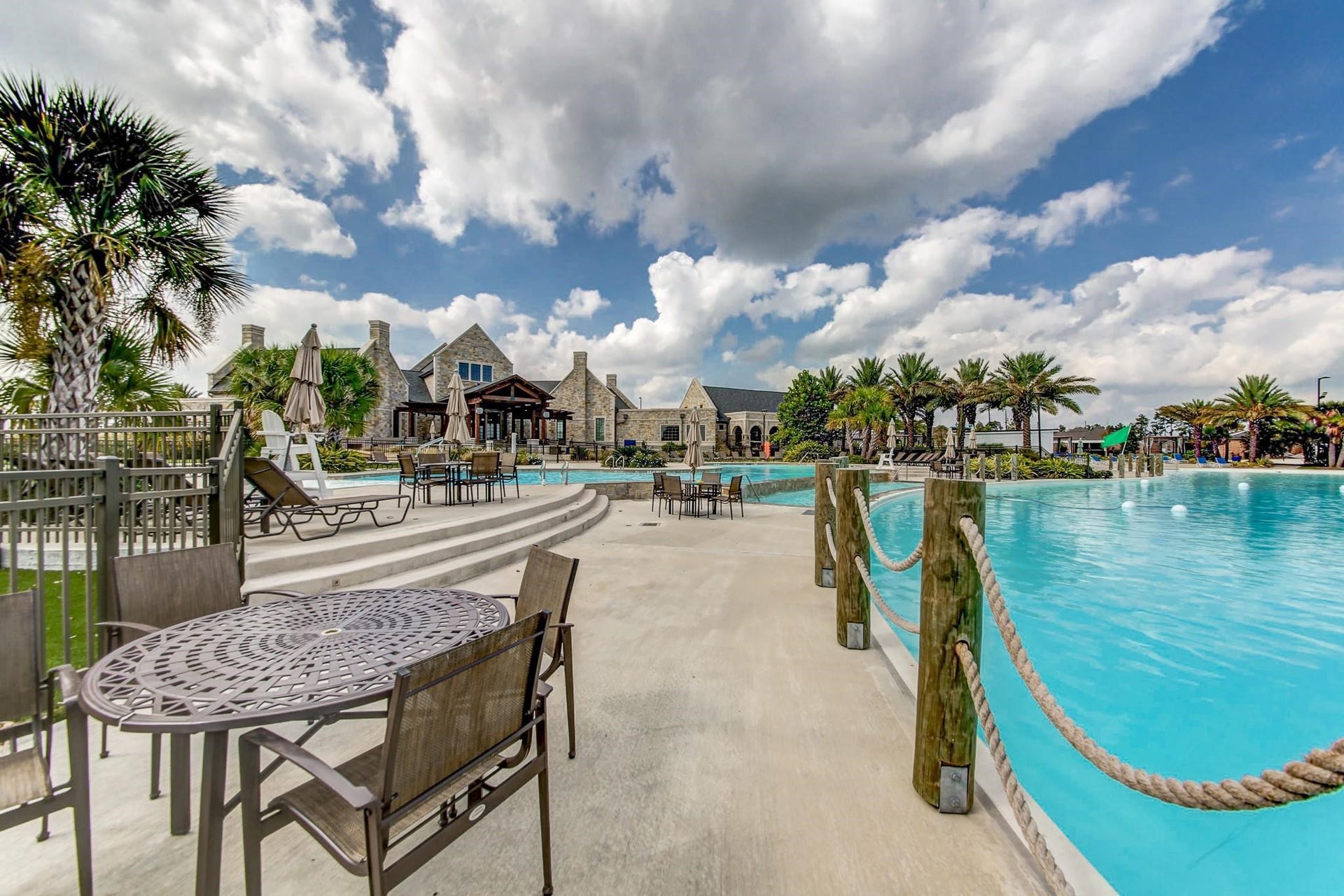 15611 Kirkton Raye Drive, Humble, TX 77346 Infinity-edge pool , separates resort-style pool, and splash pads adjacent to the lagoon.