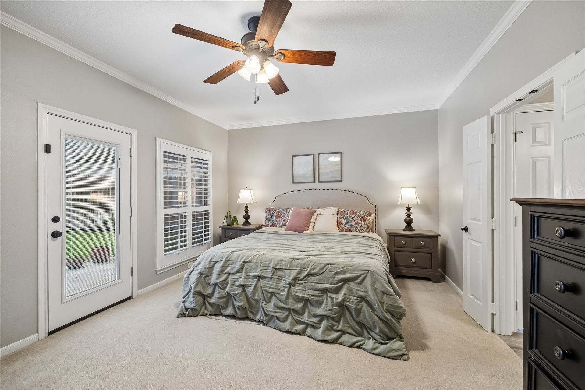 2411 Kings Lodge Drive, Kingwood, TX 77345 Spacious master bedroom with large windows and glass doors leading to your backyard oasis.