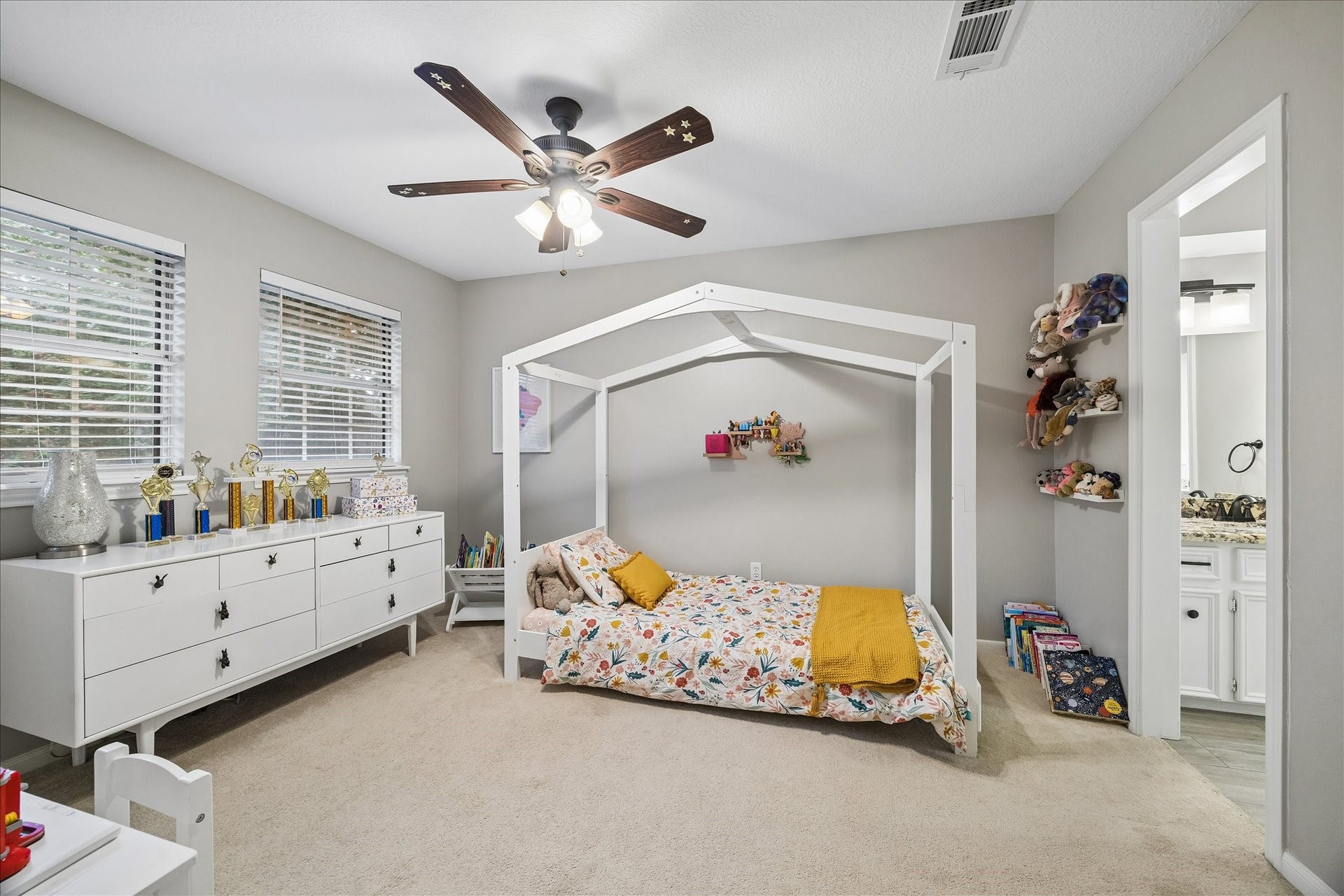 2411 Kings Lodge Drive, Kingwood, TX 77345 Secondary bedroom with plush carpeting and great windows, shares a jack-and-jill bathroom with the adjacent bedroom.