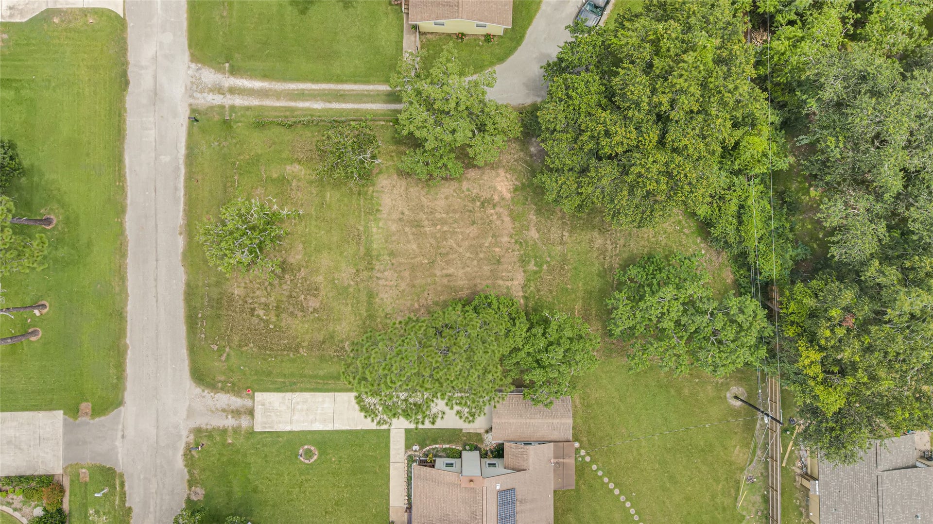 6519 Pinecrest Drive, Hitchcock, TX 77563 Spacious vacant lot nestled in a tranquil neighborhood, surrounded by lush greenery and mature trees, offering an ideal canvas for your dream home.