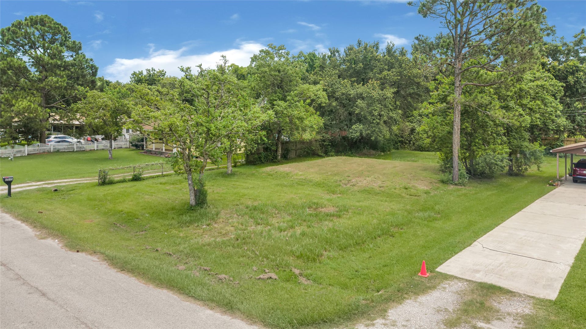 6519 Pinecrest Drive, Hitchcock, TX 77563 Expansive vacant lot with lush greenery, nestled in a serene neighborhood, offers an ideal setting for building your dream home.