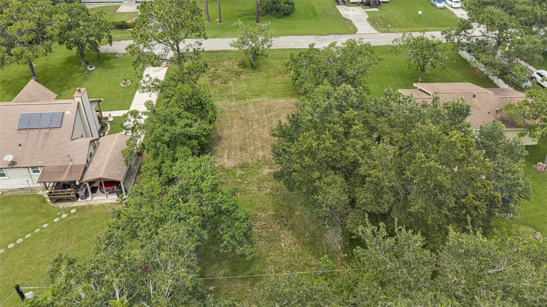 6519 Pinecrest Drive, Hitchcock, TX 77563 Expansive, lush lot surrounded by mature trees, offering a serene setting and ample space for your dream home.