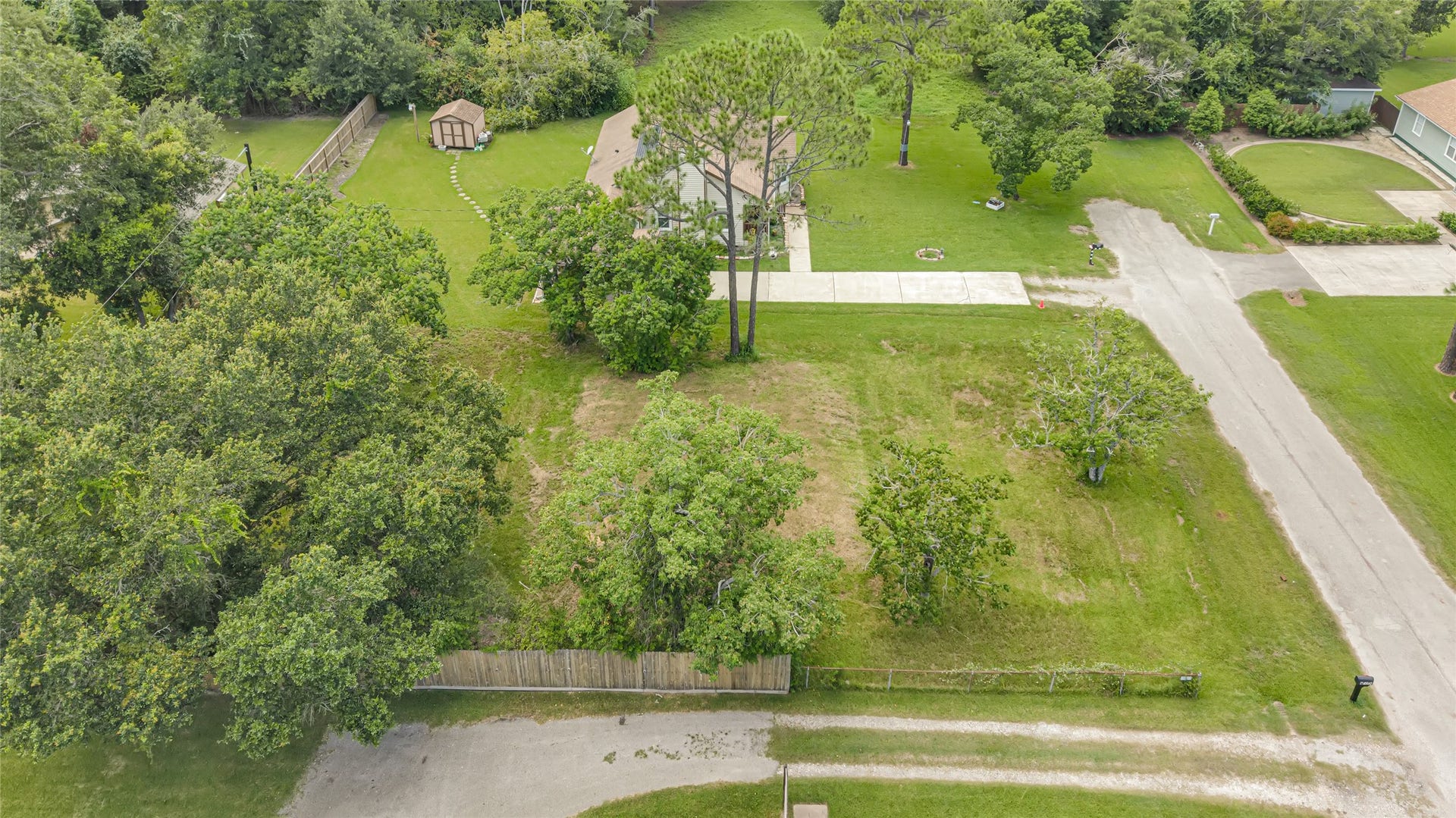 6519 Pinecrest Drive, Hitchcock, TX 77563 Expansive property featuring a charming home nestled among mature trees, with a spacious yard and a convenient shed, offering plenty of outdoor space and privacy.