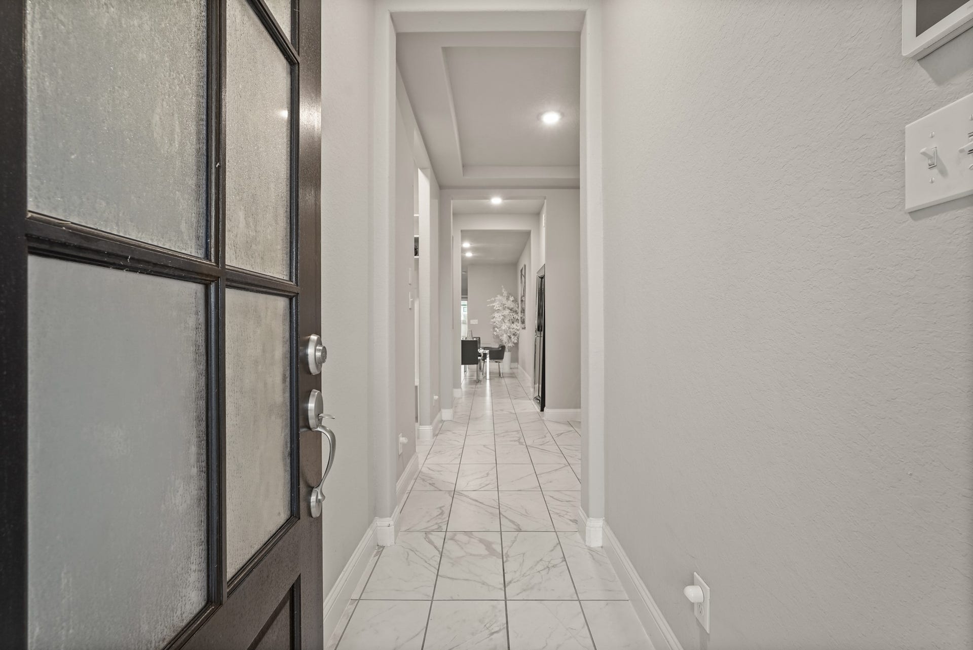 1710 Forest Mist Drive, Missouri City, TX 77459 Step inside to a grand first impression with this long, sophisticated foyer. High-gloss, large-format marble-patterned porcelain tile that bounces light and expands the space.