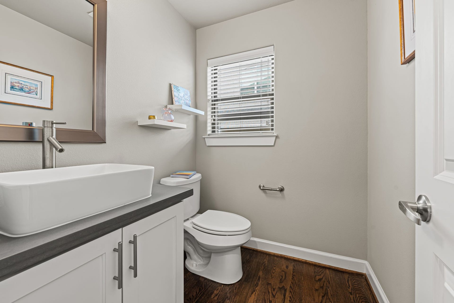 868 Wakefield Drive, #B, Houston, TX 77018 A rectangular vessel sink brings a sculptural touch to the powder room. Clean lines and a restrained palette create a polished space for guests to refresh.