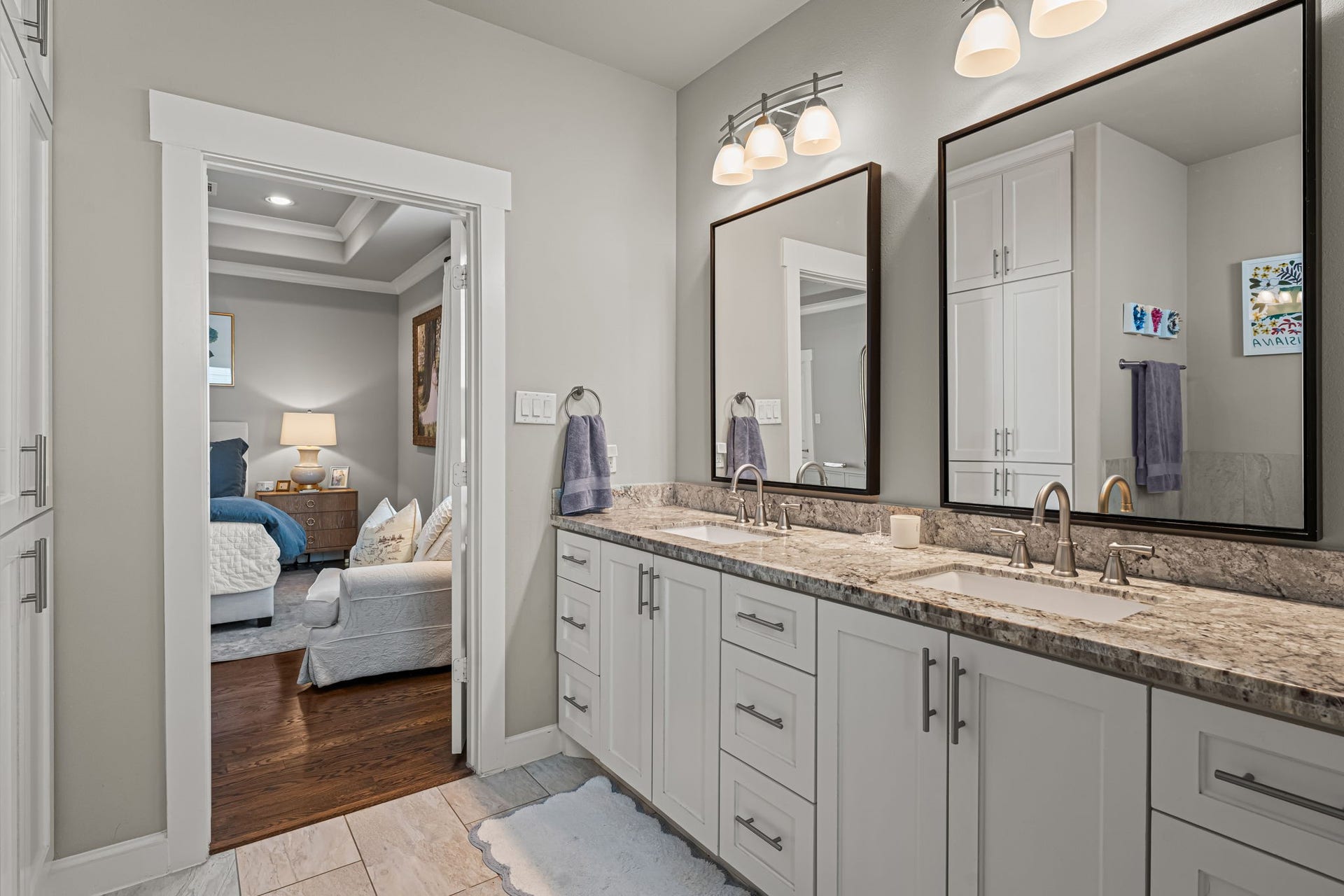 868 Wakefield Drive, #B, Houston, TX 77018 Framed mirrors and gleaming fixtures bring a tailored finish to the primary vanity. An extended counter and plentiful drawers keep daily essentials neatly organized.