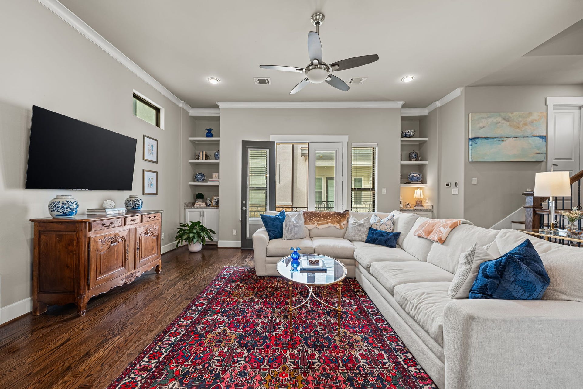 868 Wakefield Drive, #B, Houston, TX 77018 Glazed balcony doors draw the eye toward the outdoors and brighten the living room. The covered outdoor space extends the possibilities for a quiet morning or an evening breeze.