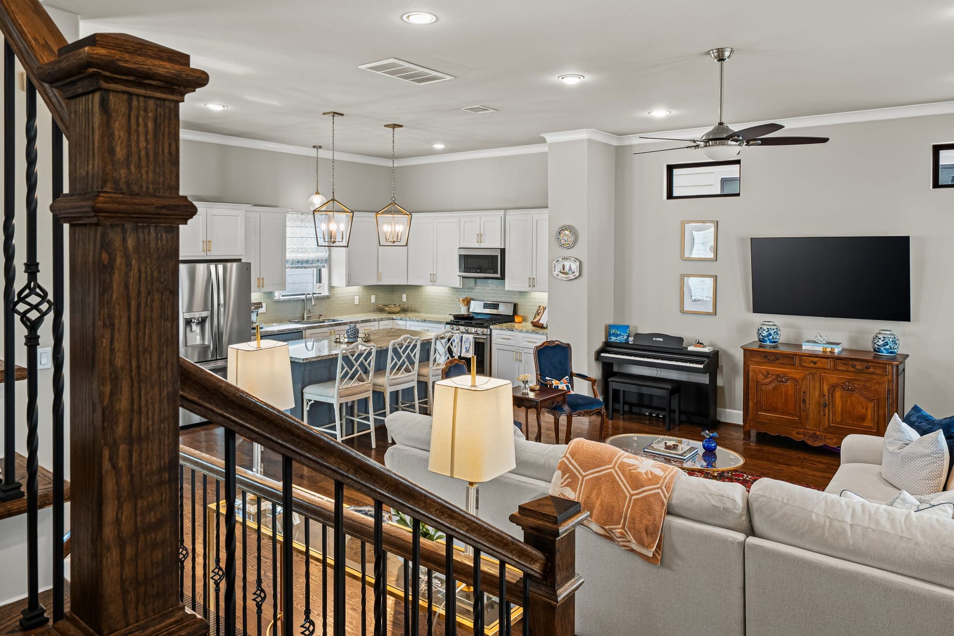 868 Wakefield Drive, #B, Houston, TX 77018 A broad view across the gathering spaces reveals the home's easy, connected layout. Wood and iron detailing provide a graceful border while leaving the kitchen and living area comfortably in view.