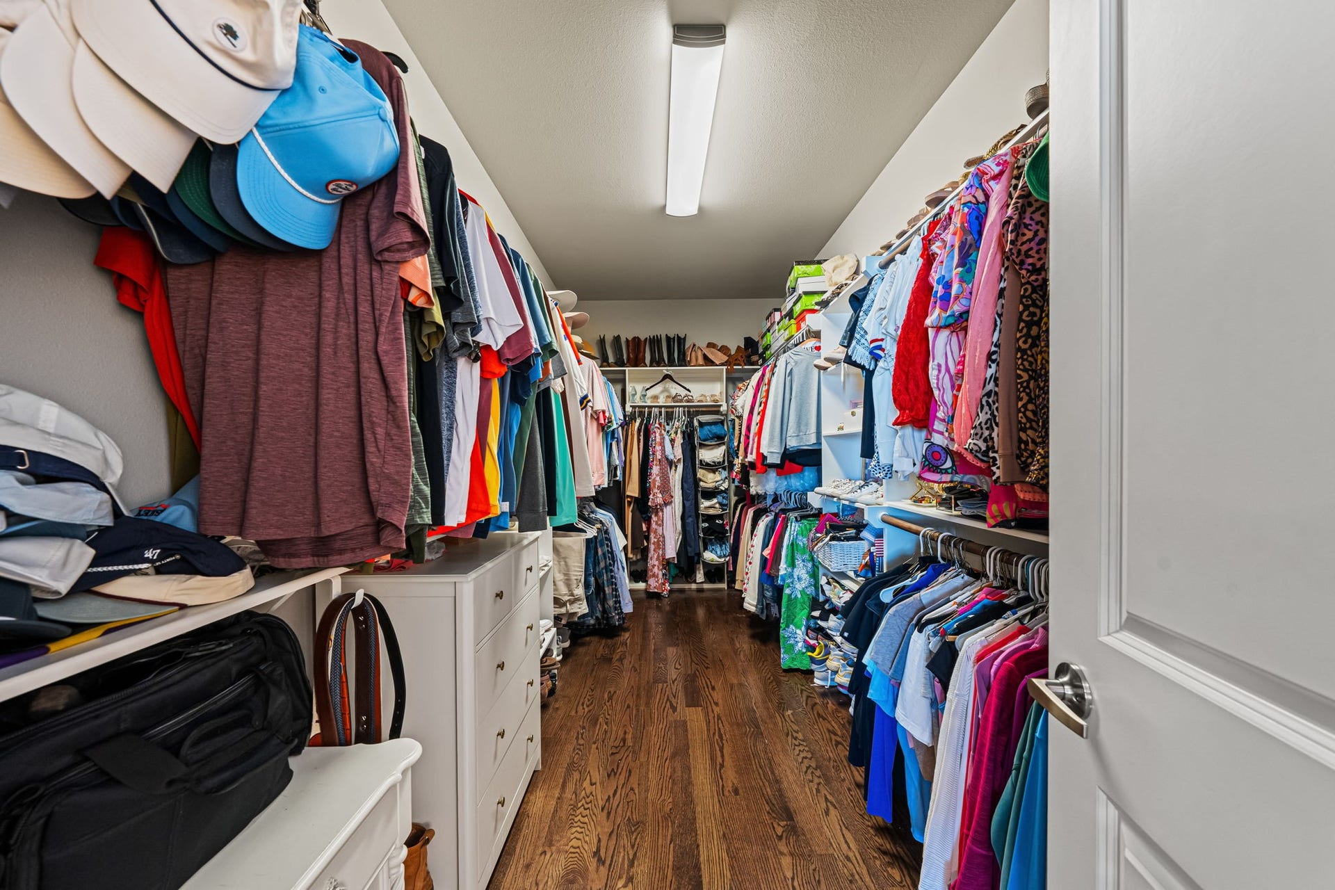 868 Wakefield Drive, #B, Houston, TX 77018 A spacious primary walk-in closet offers hanging space on both sides, with overhead shelving to keep seasonal pieces neatly tucked away.