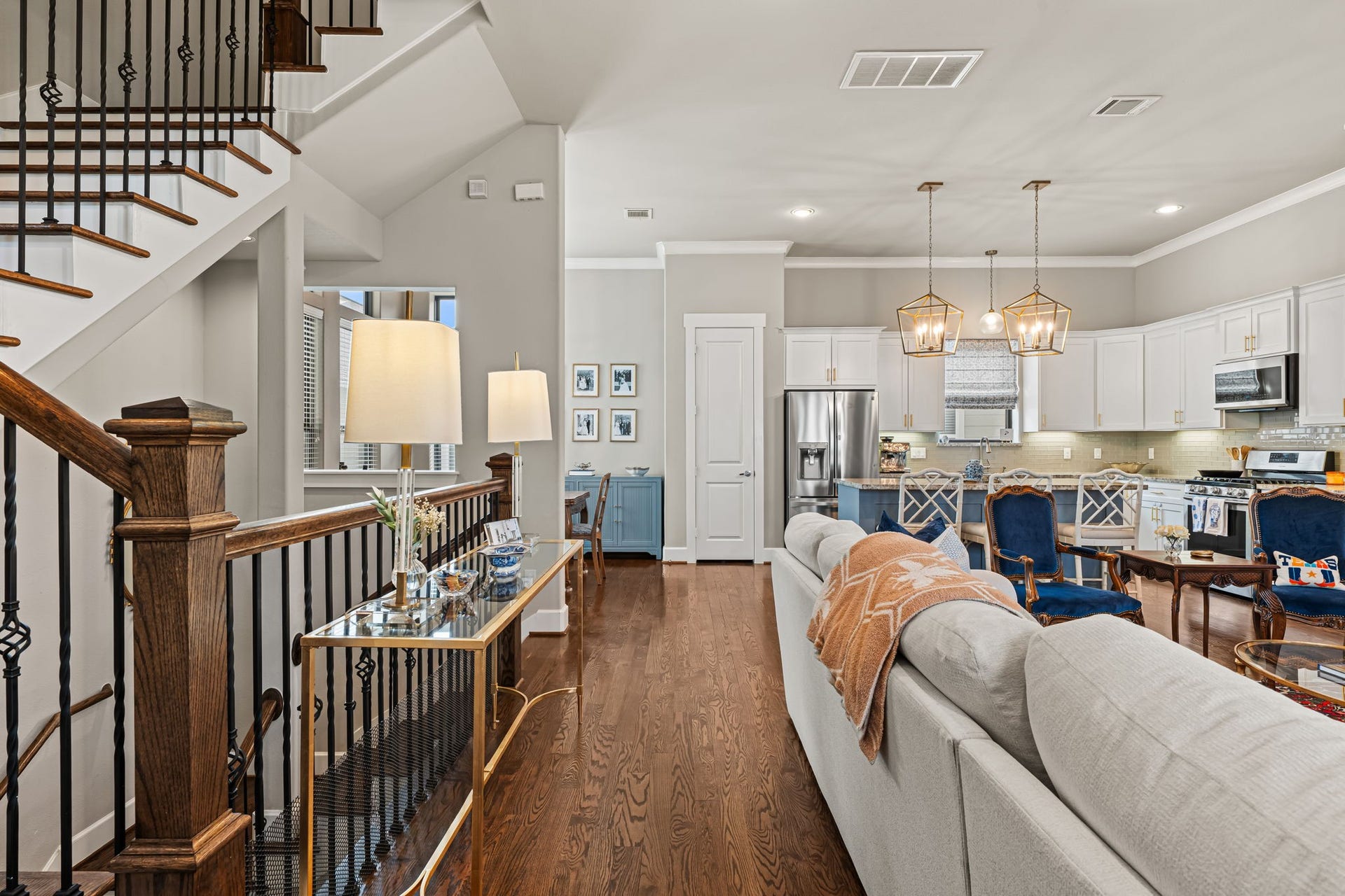 868 Wakefield Drive, #B, Houston, TX 77018 Decorative ironwork and a polished wood handrail lend the living area's edge a touch of craftsmanship. Beyond the railing, the open plan maintains a relaxed connection between daily routines and time together.