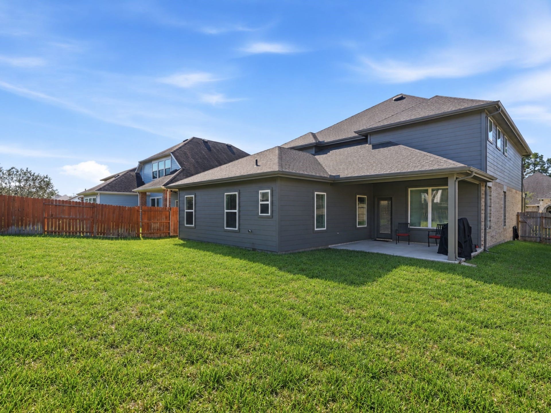322 Westlake Terrace Drive, Conroe, TX 77304 Backyard is perfect for play. Notice the covered back patio.