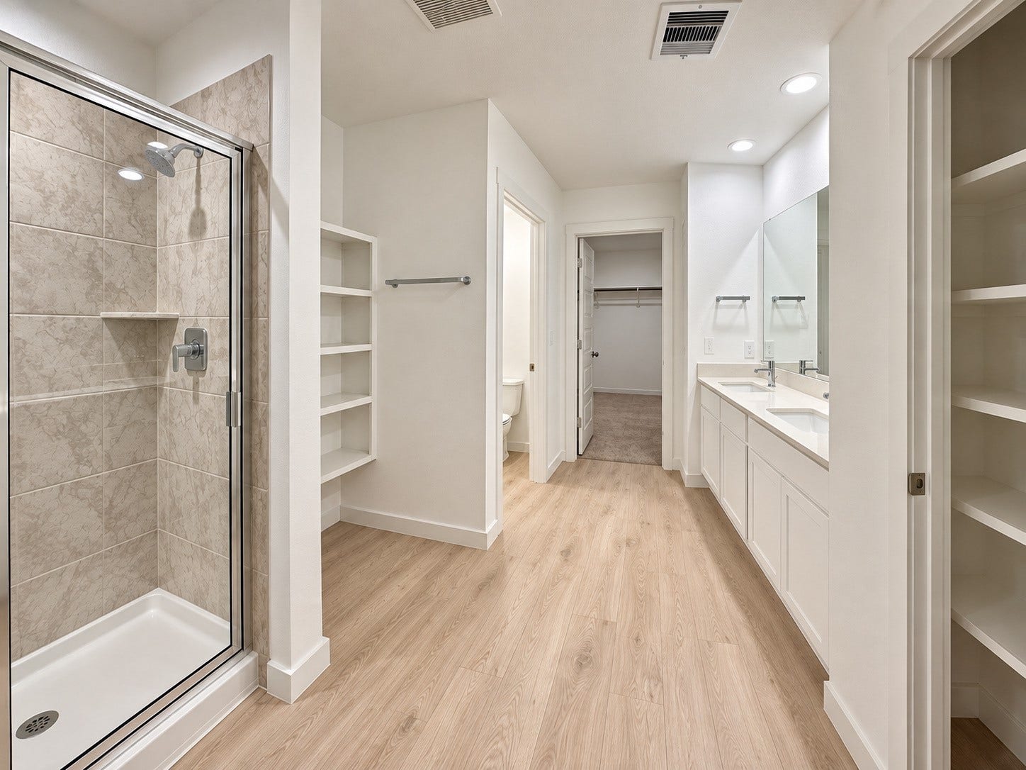 31742 Margaret Woods Lane, Fulshear, TX 77441 Primary bathroom suite with double sinks, walk in shower, linen closet, shelving and a powder room with privacy door.