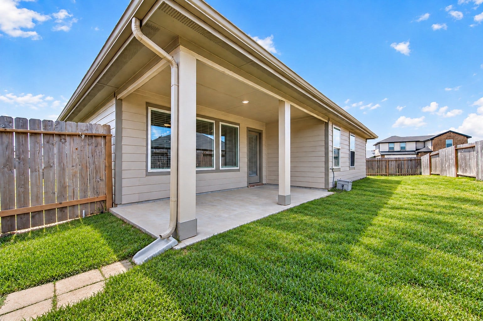 31742 Margaret Woods Lane, Fulshear, TX 77441 Covered patio in the backyard. The yard extends around the side of the home. Perfect for kiddos and pets.