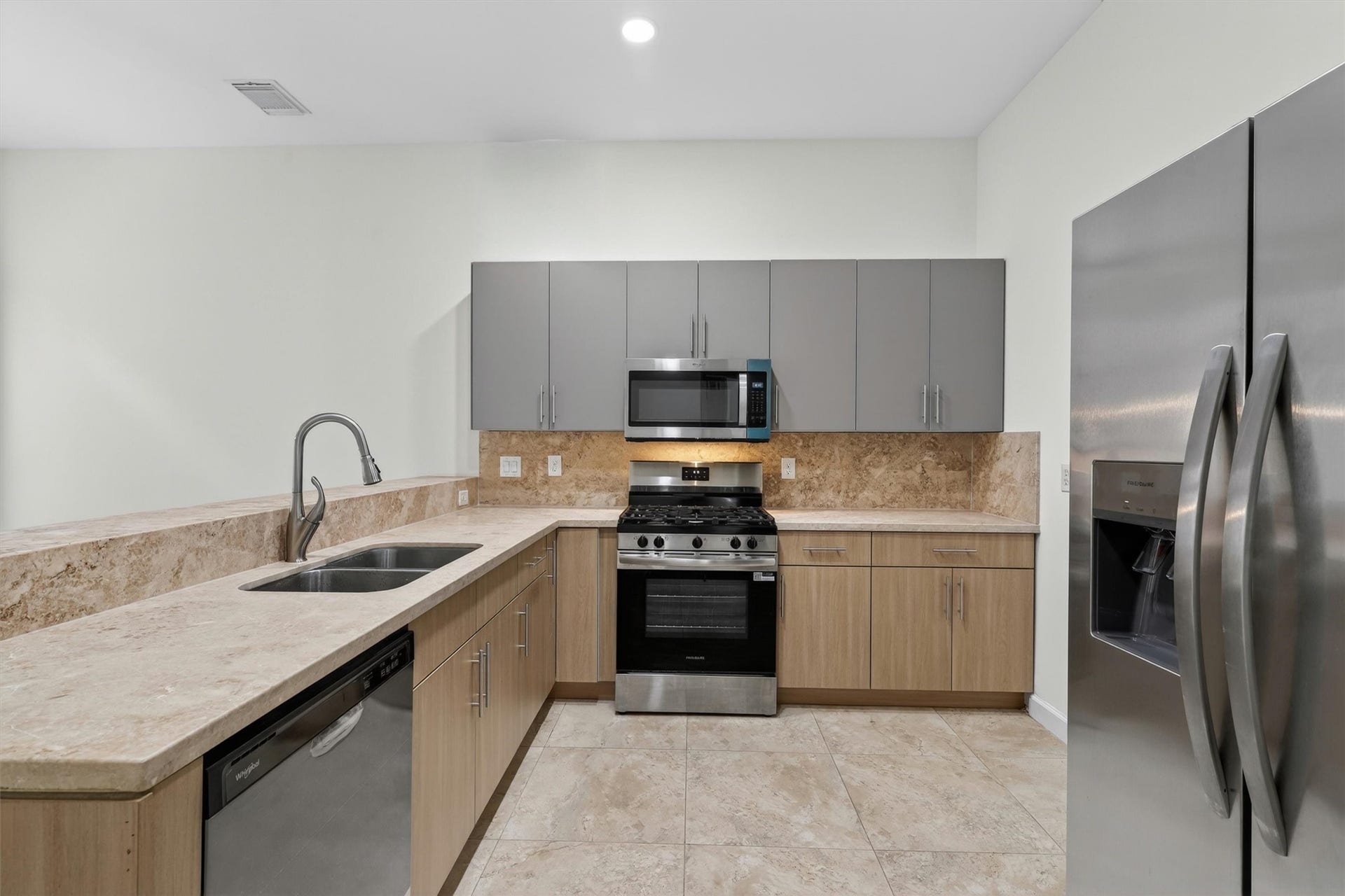 4720 Post Oak Timber Drive, #23, Houston, TX 77056 Beautifully upgraded kitchen with European frameless cabinetry and imported Cappuccino marble countertops.