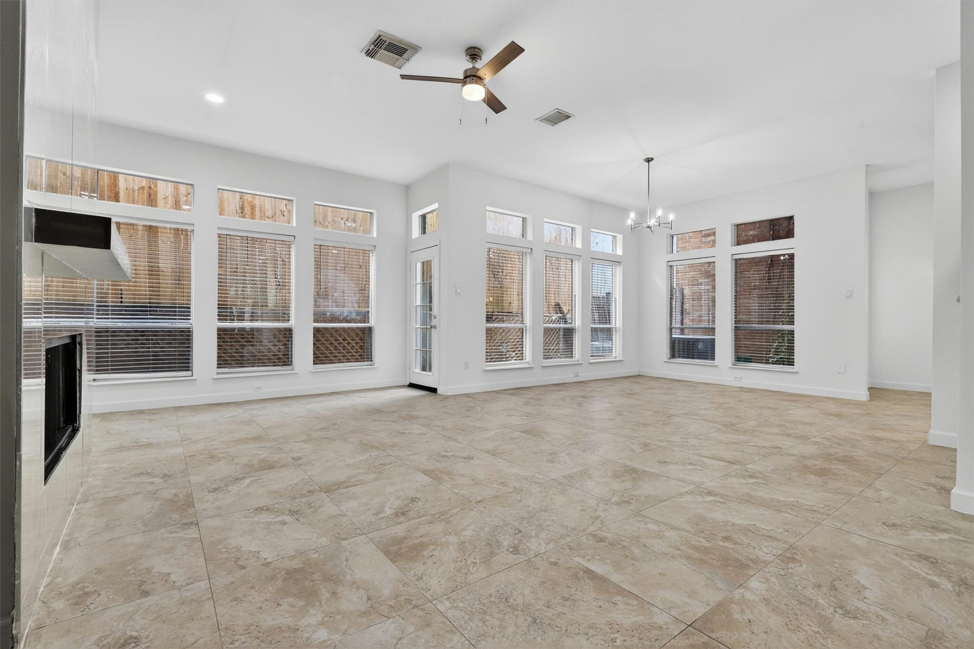 4720 Post Oak Timber Drive, #23, Houston, TX 77056 Spacious open-concept living area featuring designer lighting and porcelain fireplace feature wall.