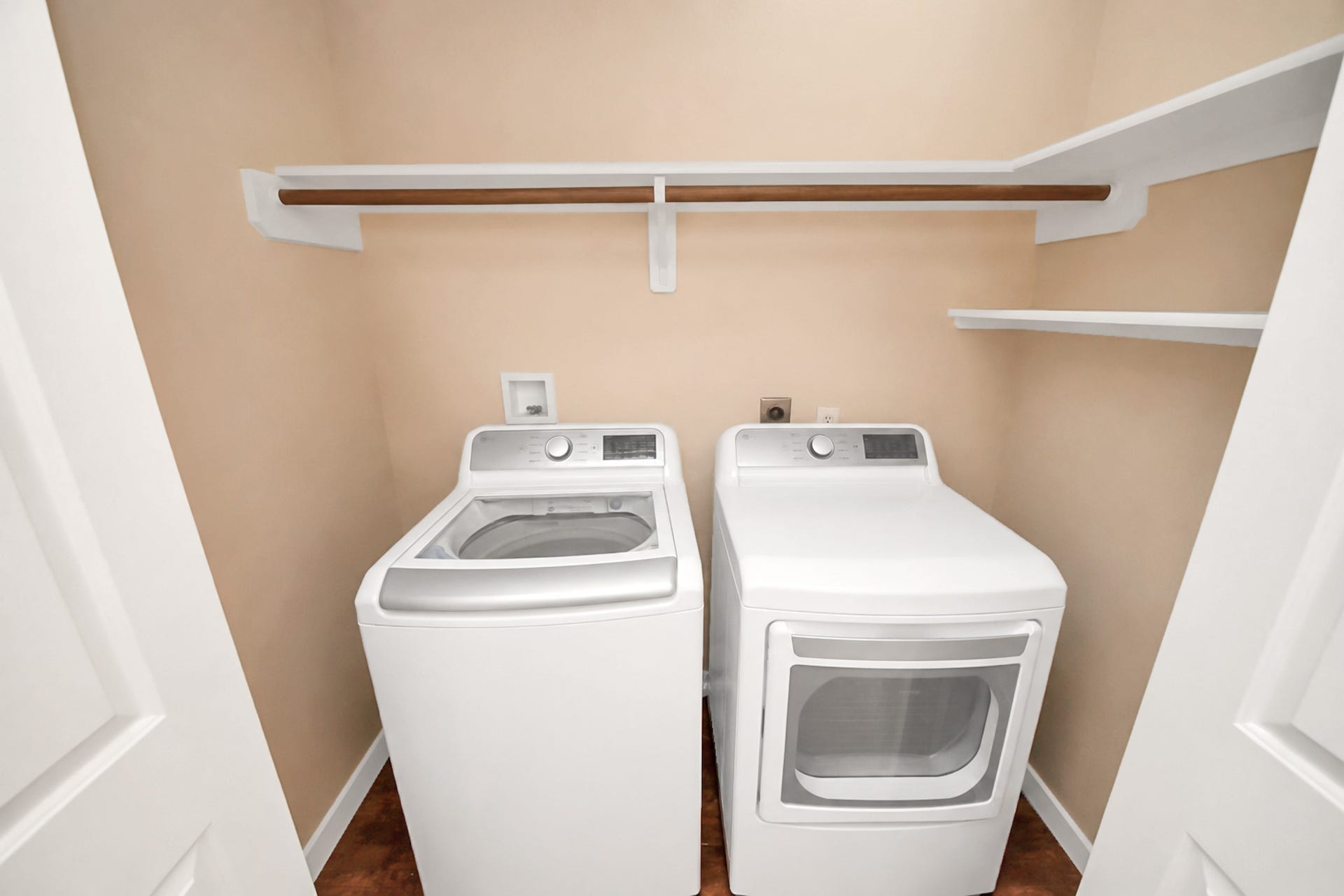 4634 Jaymar Dr, Sugar Land, TX 77479 Indoor laundry area with full-size connections and overhead shelving.
