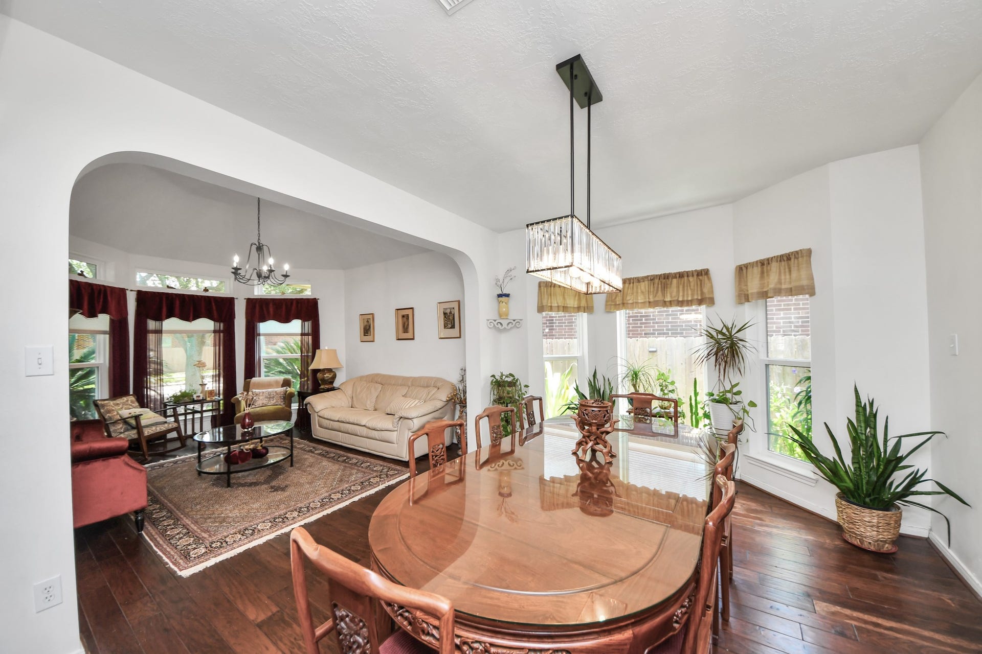 4634 Jaymar Dr, Sugar Land, TX 77479 Large windows bring plenty of natural light into the connected formal living and dining spaces.