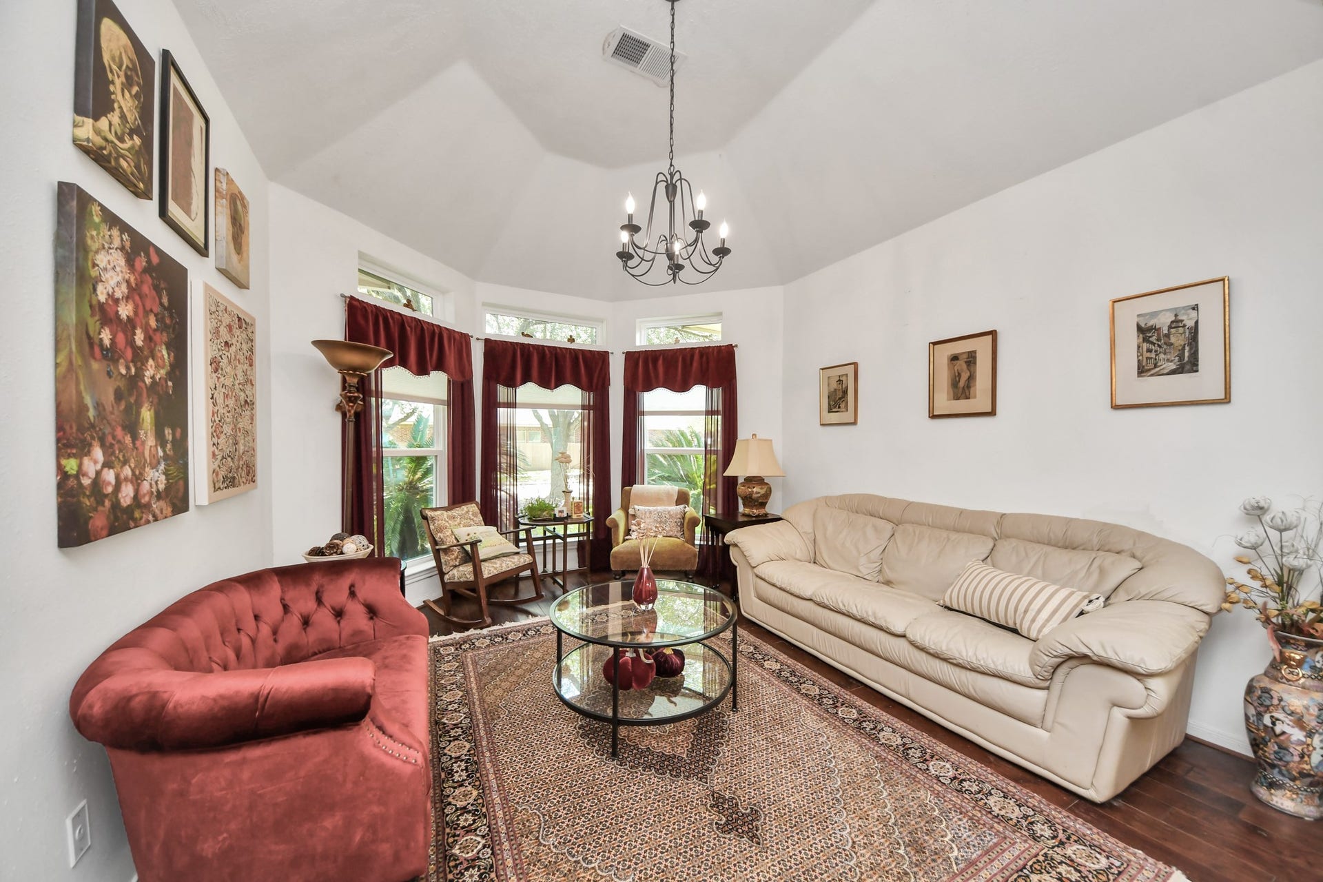 4634 Jaymar Dr, Sugar Land, TX 77479 Formal living room with a raised ceiling and a curved wall of windows.