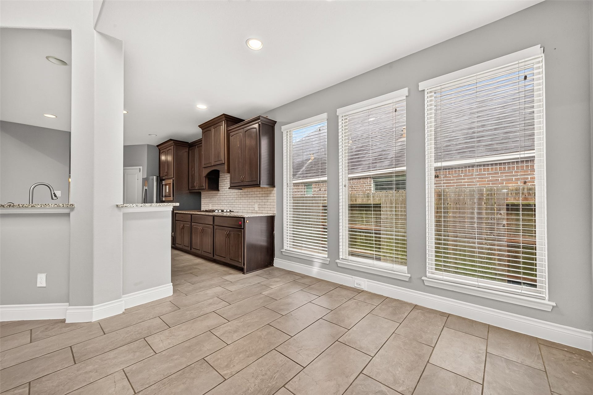 23335 Peareson Bend Lane, Richmond, TX 77469 Bright breakfast area featuring a wall of windows that fills the space with natural light, creating the perfect setting for casual dining and morning coffee