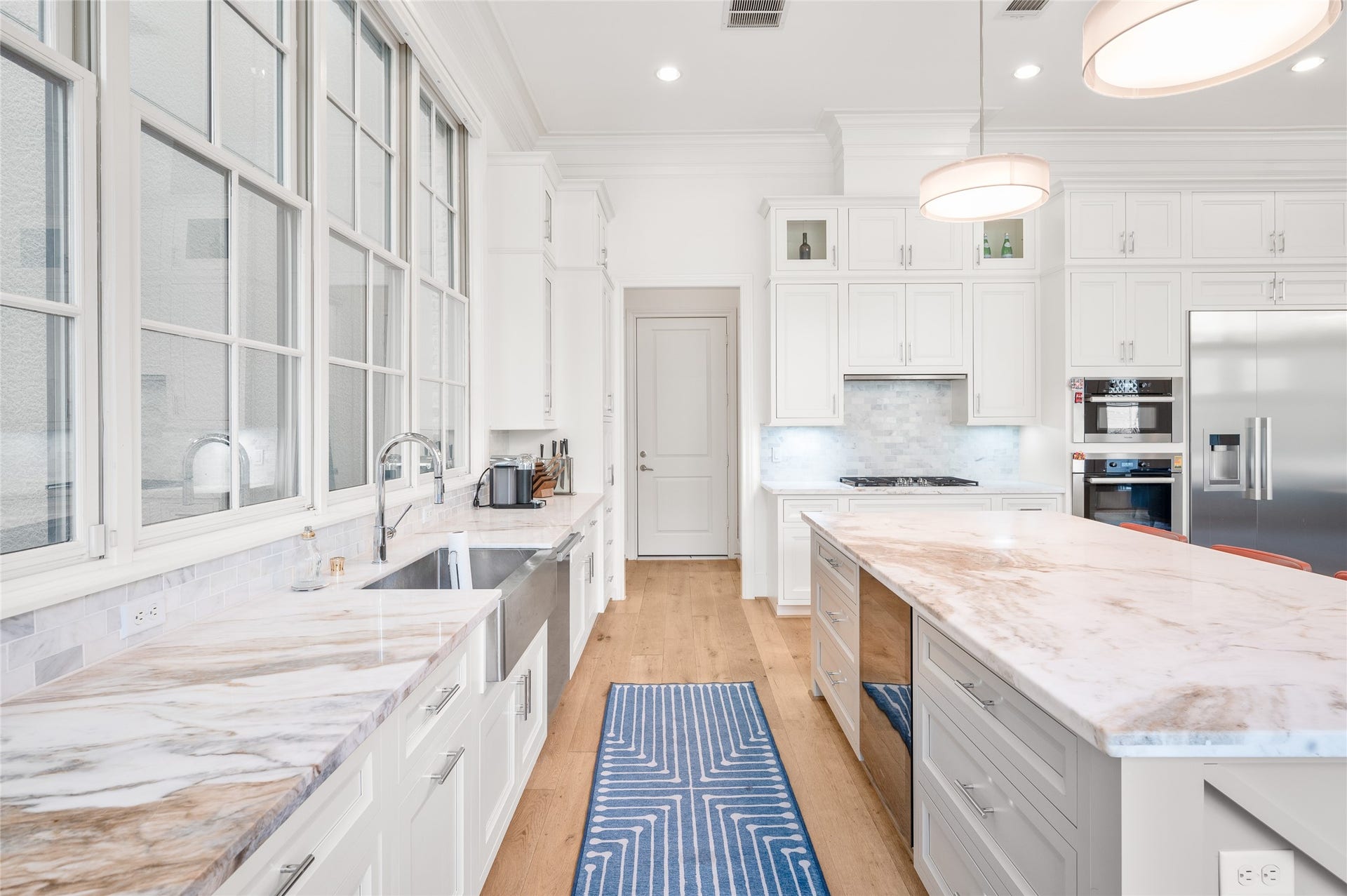 7554 Little Caprese Lane, Houston, TX 77055 A closer look at the kitchen's marble countertops, farmhouse-style sink, polished fixtures, and tailored cabinetry with integrated storage.
