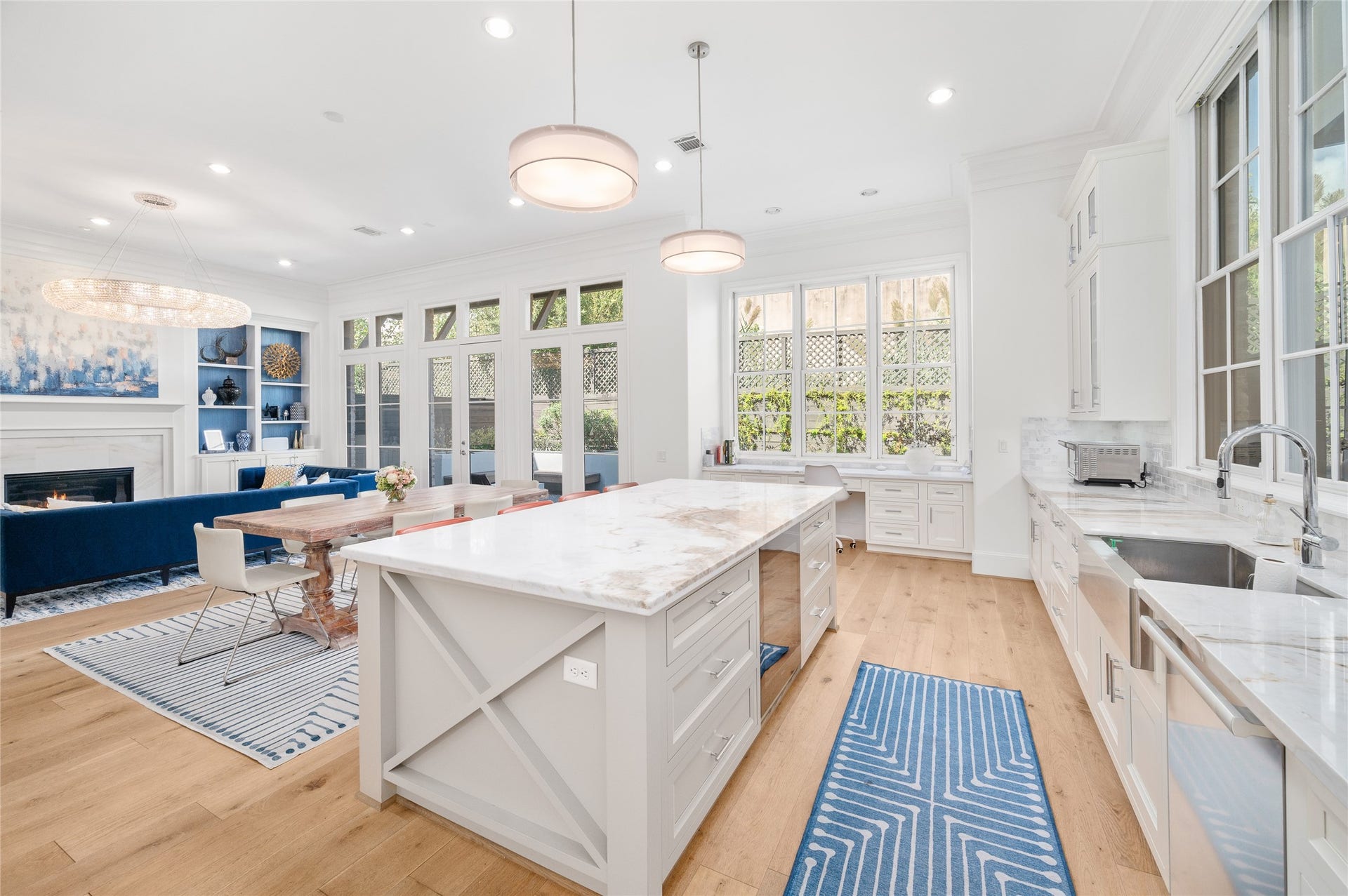 7554 Little Caprese Lane, Houston, TX 77055 The kitchen's central island overlooks the breakfast area and adjoining living room, creating an open, connected floor plan with views toward the backyard space.