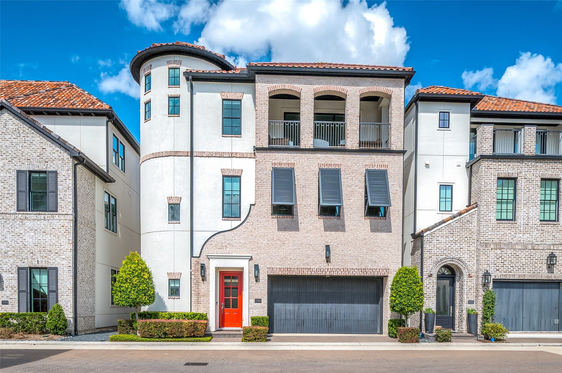 7554 Little Caprese Lane, Houston, TX 77055 Welcome to 7554 Little Caprese, an exquisite Traditional/ Mediterranean -inspired residence in Ravenna, showcasing refined architectural details, a distinctive turret, elegant arched balconies, and a sophisticated blend of brick and stucco, complemented by a classic red tile roof.