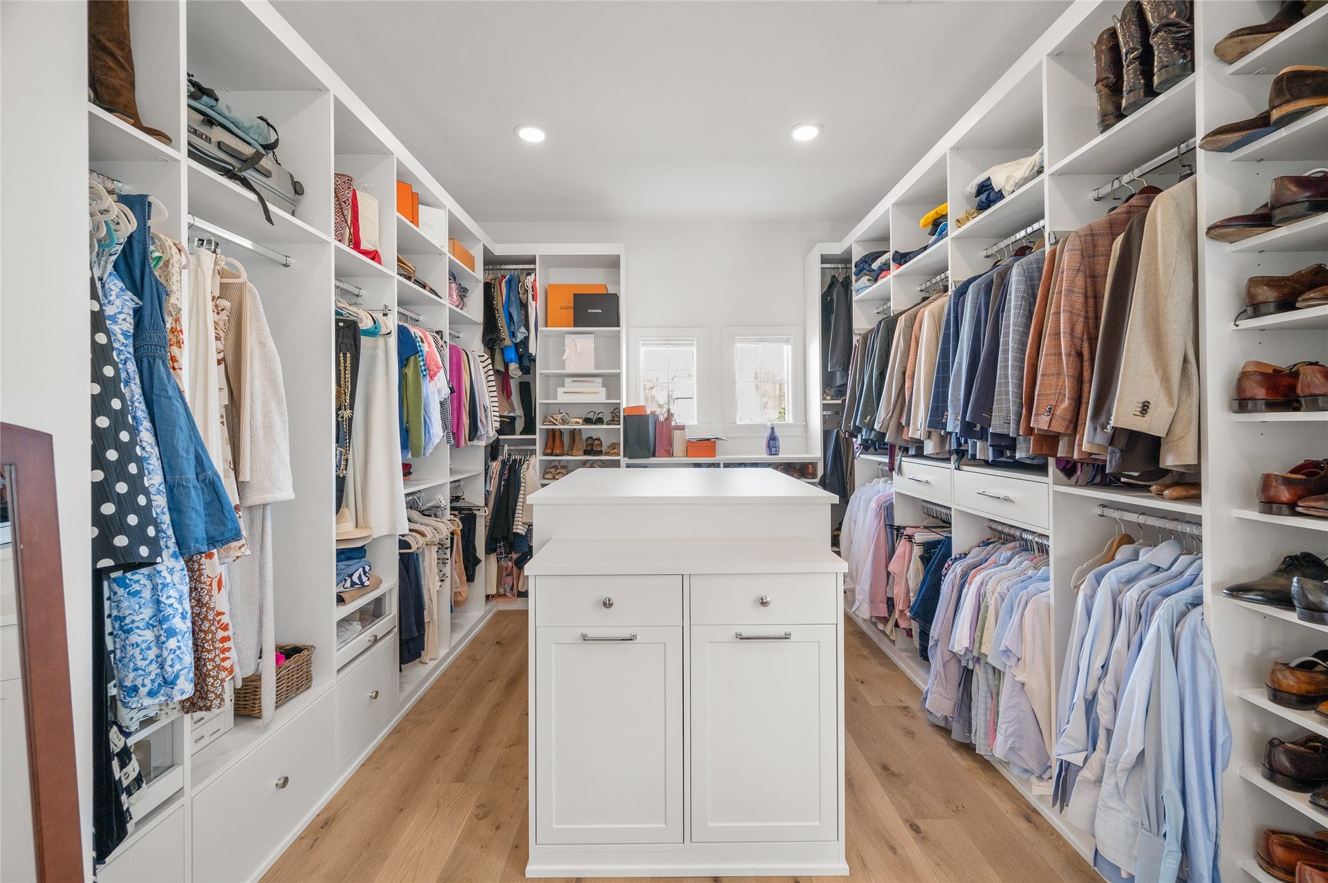 7554 Little Caprese Lane, Houston, TX 77055 Generously sized walk-in closet with custom built-in shelving, hanging storage, drawers, and a central storage island.