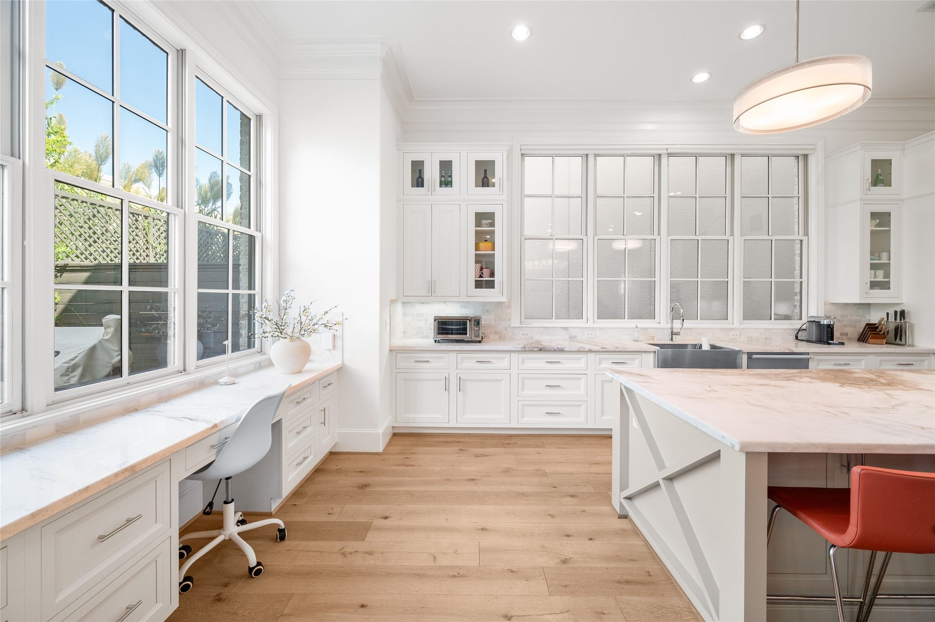 7554 Little Caprese Lane, Houston, TX 77055 An additional kitchen perspective reveals a dedicated built-in workspace overlooking the backyard, complemented by generous counter space and natural light.