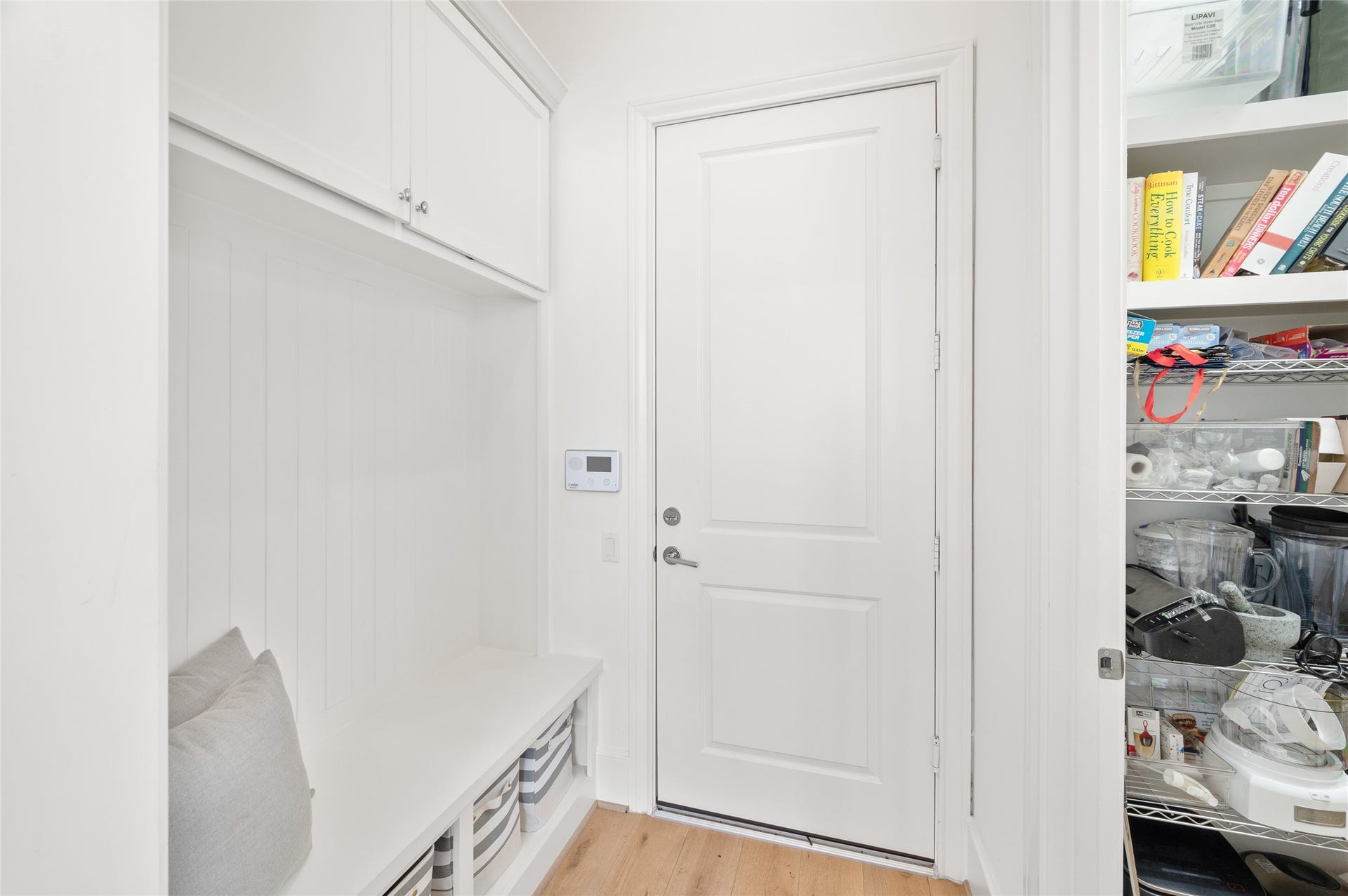 7554 Little Caprese Lane, Houston, TX 77055 Practical mudroom with a built-in bench, overhead cabinetry, and convenient access to the walk-in pantry and the garage.