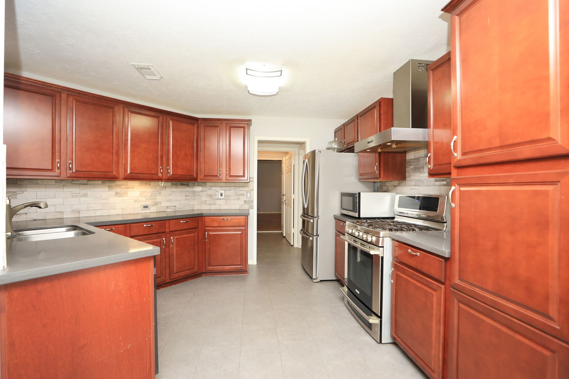 10403 Twin Oak Drive, Conroe, TX 77385 Kitchen features lots of cabinets and counters for meal prep and entertaining!