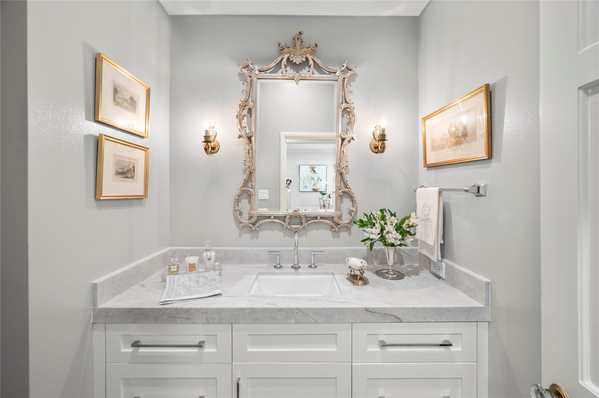 [Powder Room]
Positioned in the center hall to the side of the formal rooms, the powder room has a custom sink cabinet with quartz deck.