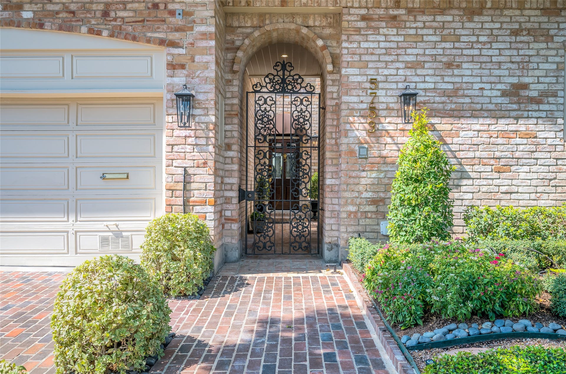 [Front Courtyard Entrance]
The shady brick-walled courtyard behind an elaborate iron gate is reminiscent of a classic residence in New Orleans Vieux Carre.