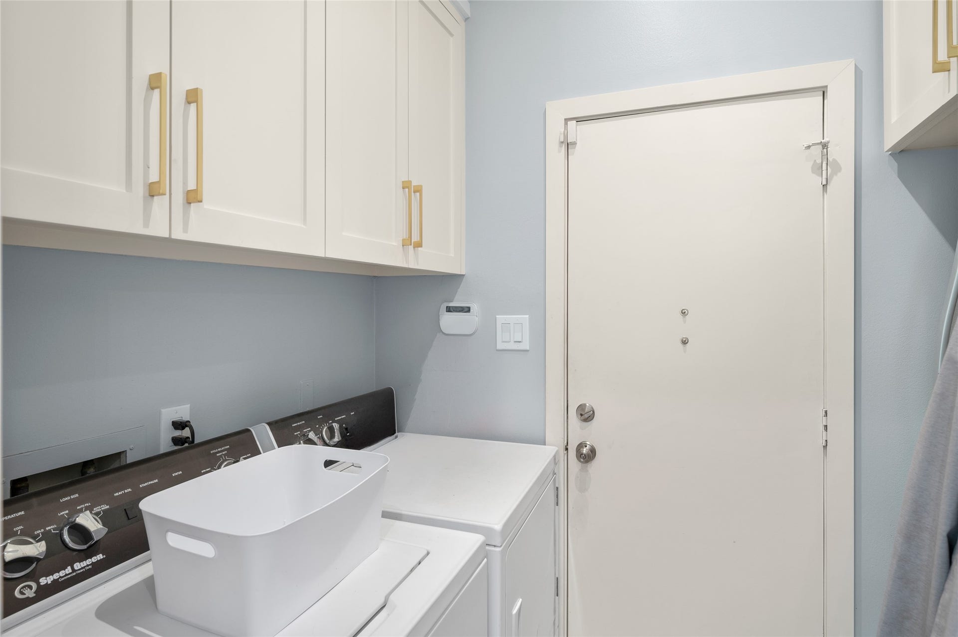 [Laundry Room]
The laundry room has abundant storage and a wall recess for second refrigerator, if desired.