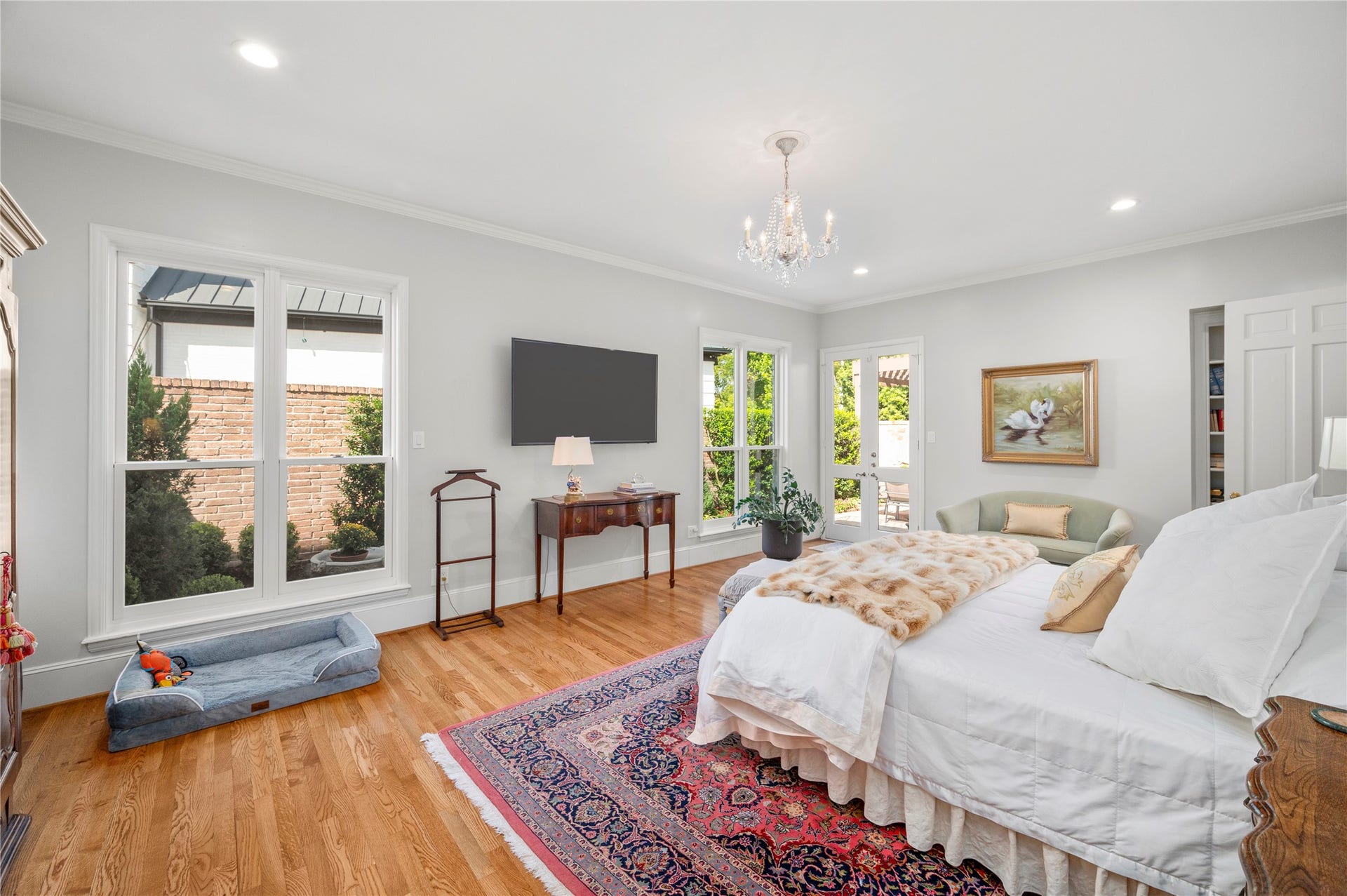 [Primary Suite]
A wide view reveals the flagstone patio that travels from outside of the living room to the primary bedroom.