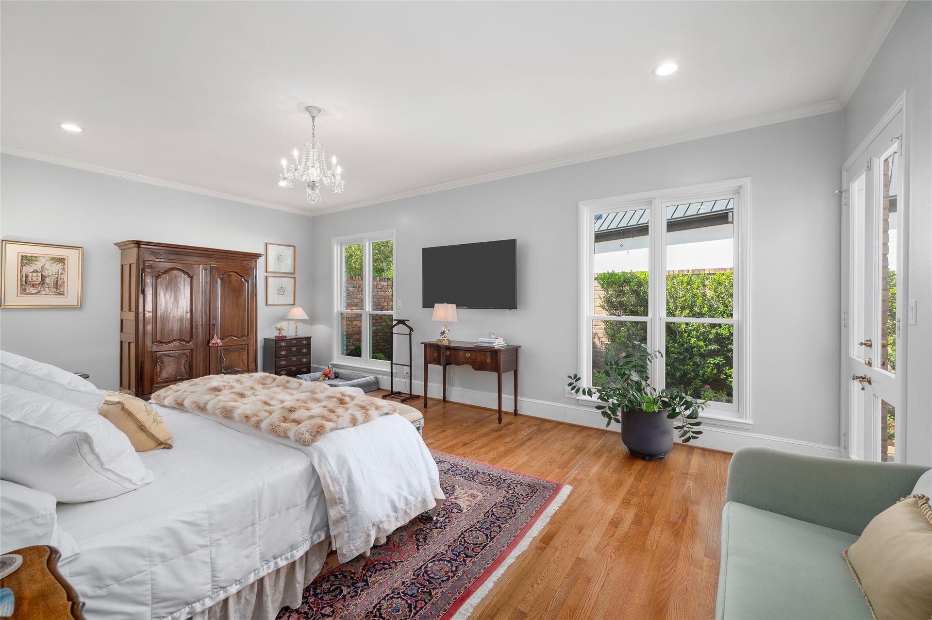 [Primary Suite]
Wide glass doors in the bedroom open to the flagstone patio and gardens.