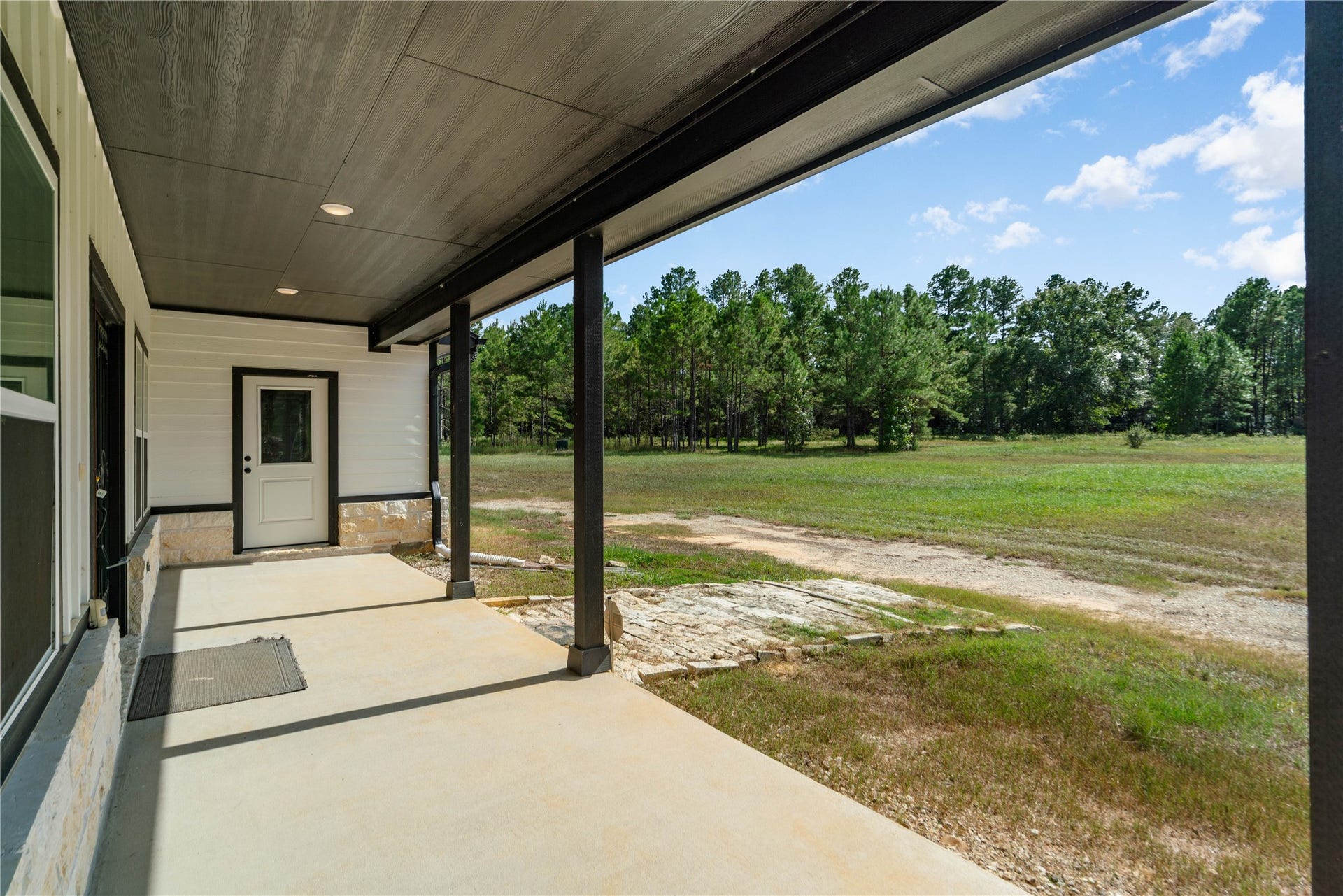 21203 Peach Wood Court, Cleveland, TX 77328 front porch with additional garage entry.