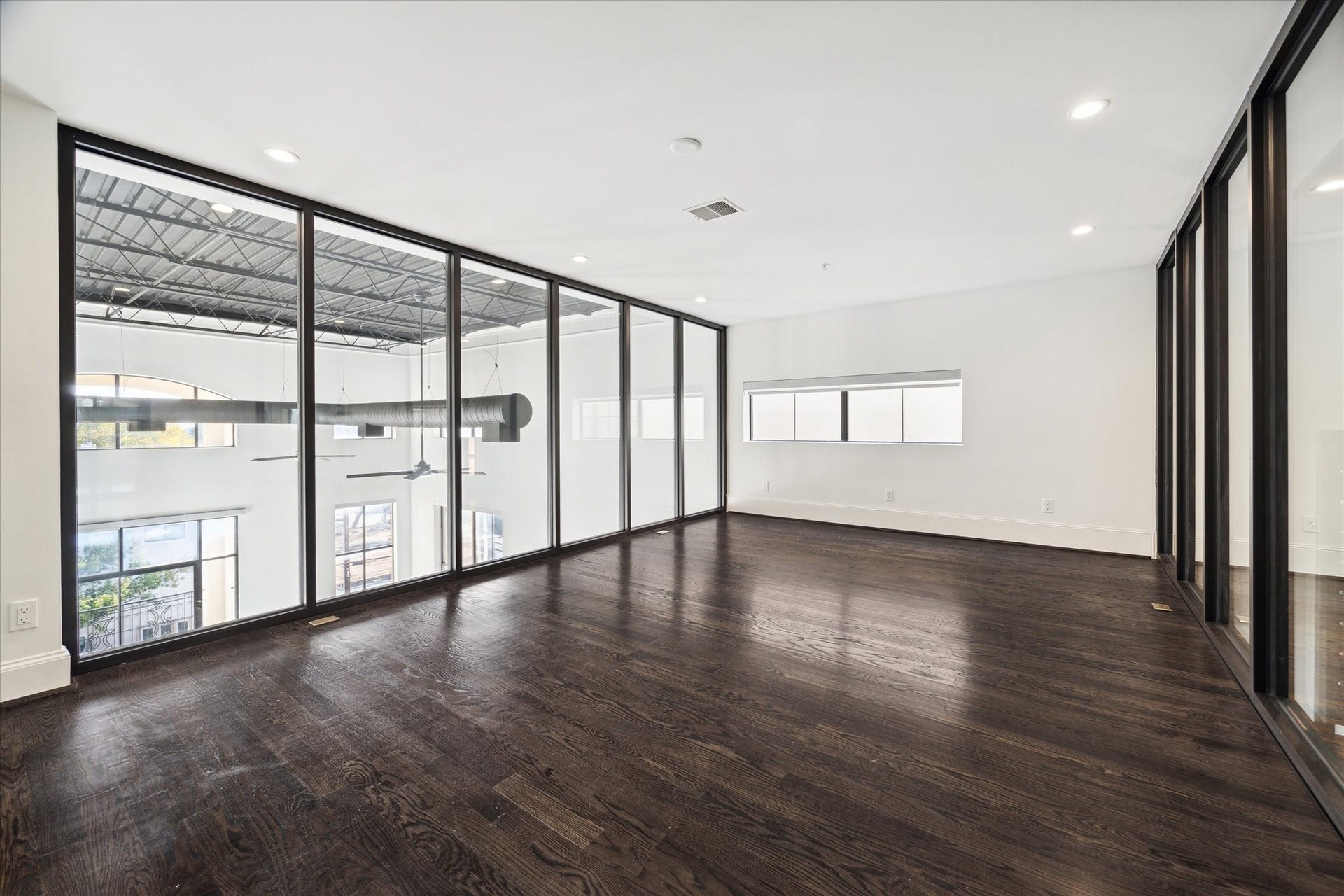 Bedroom on the 2nd floor, with big windows overlooking the first floor.