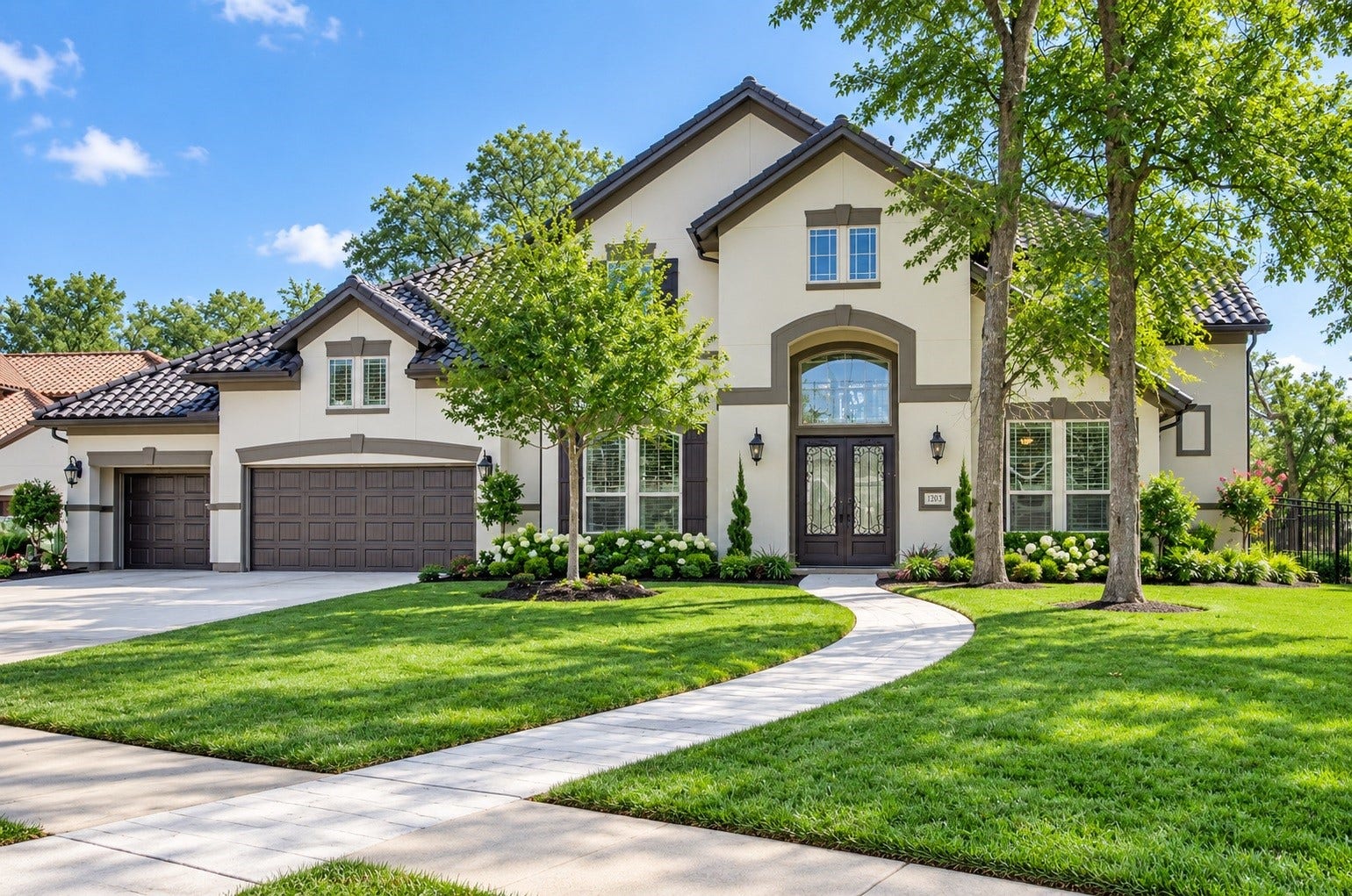 5015 Tillbuster Ponds Court, Sugar Land, TX 77479 Stunning two-story home with a charming stucco exterior, elegant arched windows, and a beautifully landscaped front yard. A wide driveway leads to a spacious three-car garage, and a welcoming path invites you to the grand entryway.