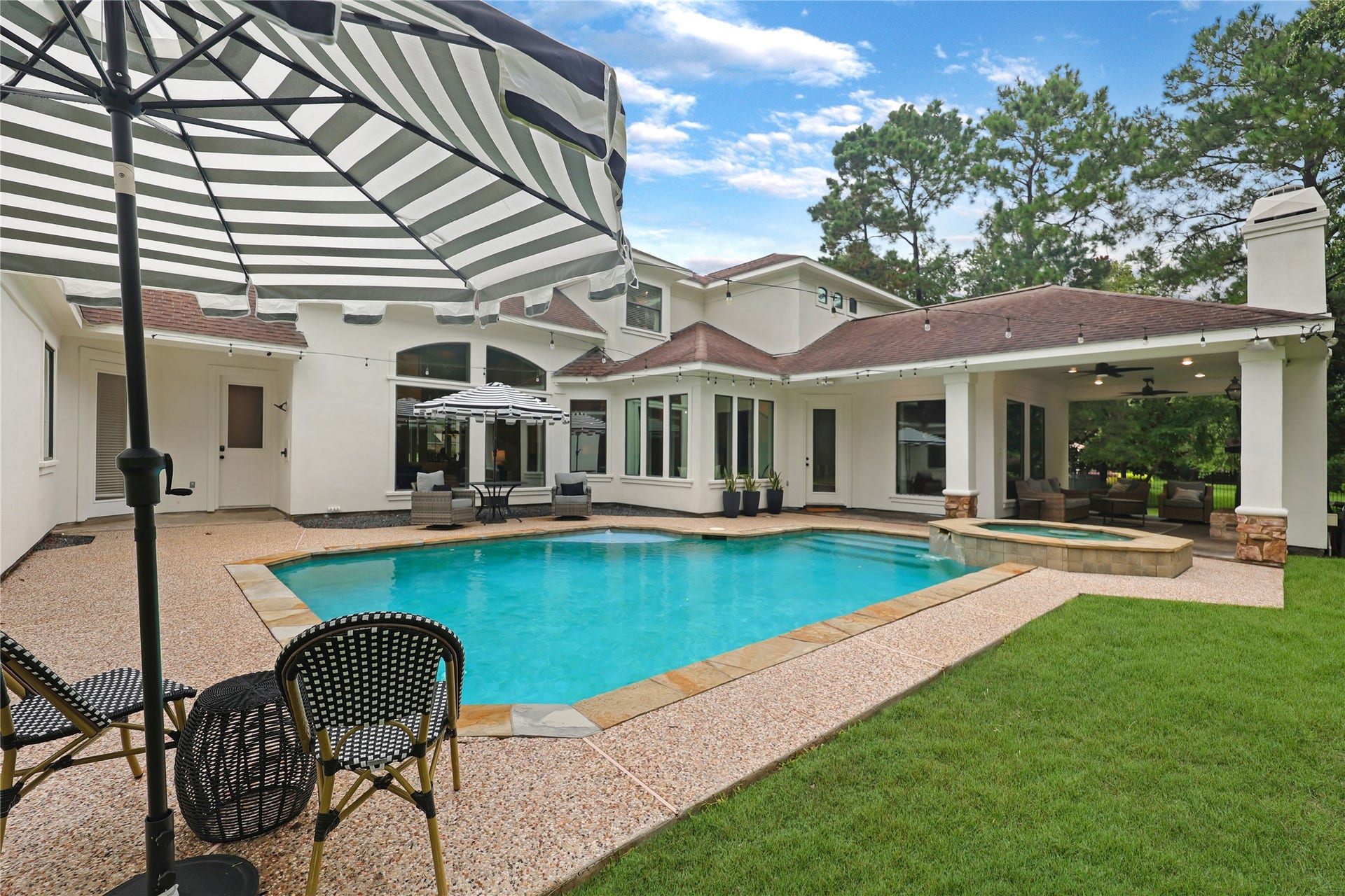 3810 Benders Lane, Spring, TX 77386 Outside, enjoy the privacy of an acre-plus lot featuring a sparkling pool and spa, along with a spacious covered back porch perfect for relaxing and entertaining.