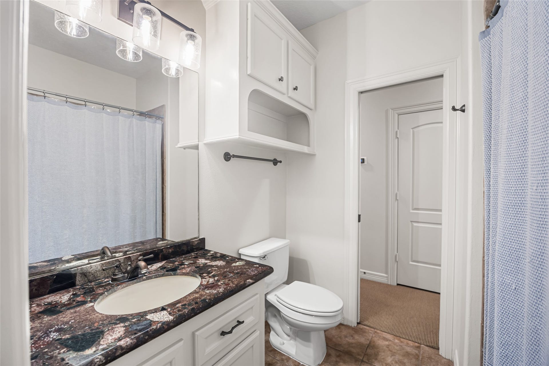 3810 Benders Lane, Spring, TX 77386 Secondary bathroom offers convenient access from both the bedroom and hallway, providing flexibility and functionality for family and guests.