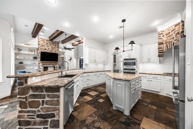 3810 Benders Lane, Spring, TX 77386 Kitchen features premium Monogram appliances installed in 2025, an oversized center island, abundant cabinetry, and a thoughtfully designed layout perfect for everyday living and entertaining.