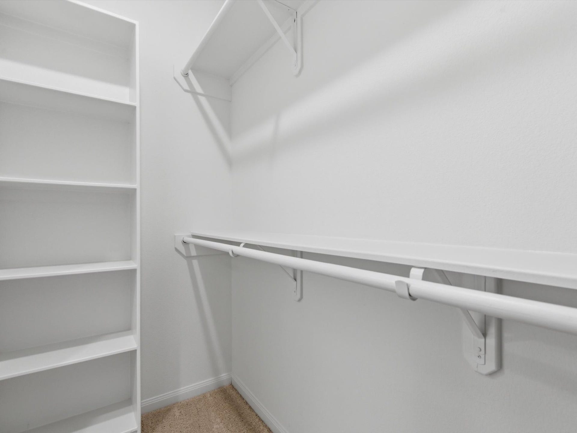The expansive primary walk-in closet offers generous built-in storage and exceptional organization.