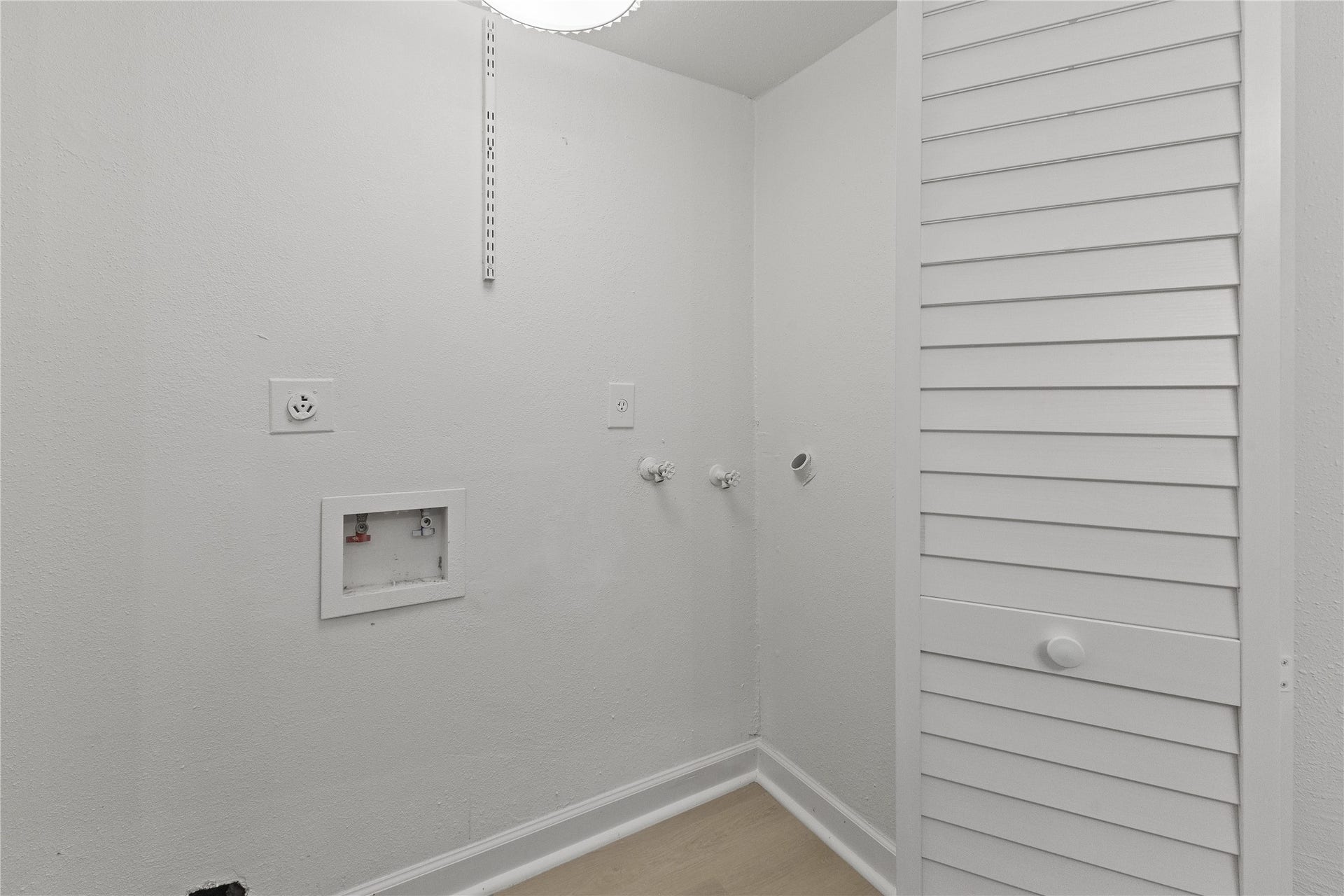 1913 Bittercreek Drive, Houston, TX 77042 A dedicated laundry area provides connections for a full-size washer and dryer, along with an adjacent utility closet.
